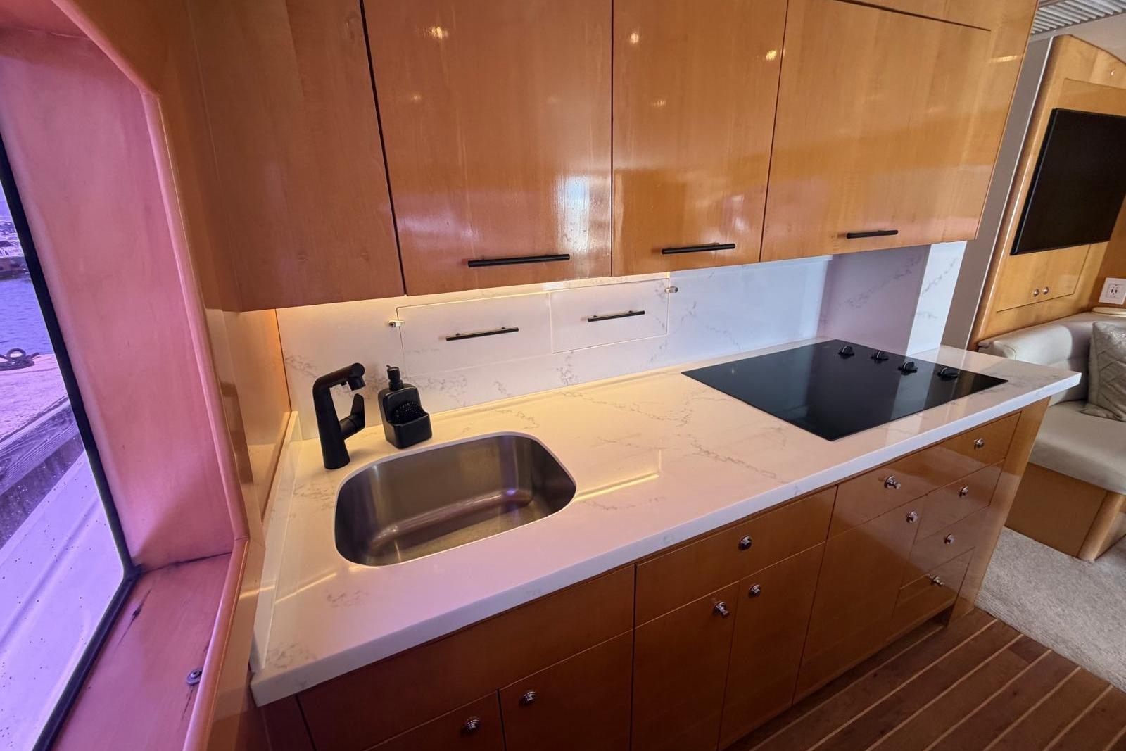 Luxurious kitchen interior of 2003 Hatteras 54 Convertible yacht with modern amenities.