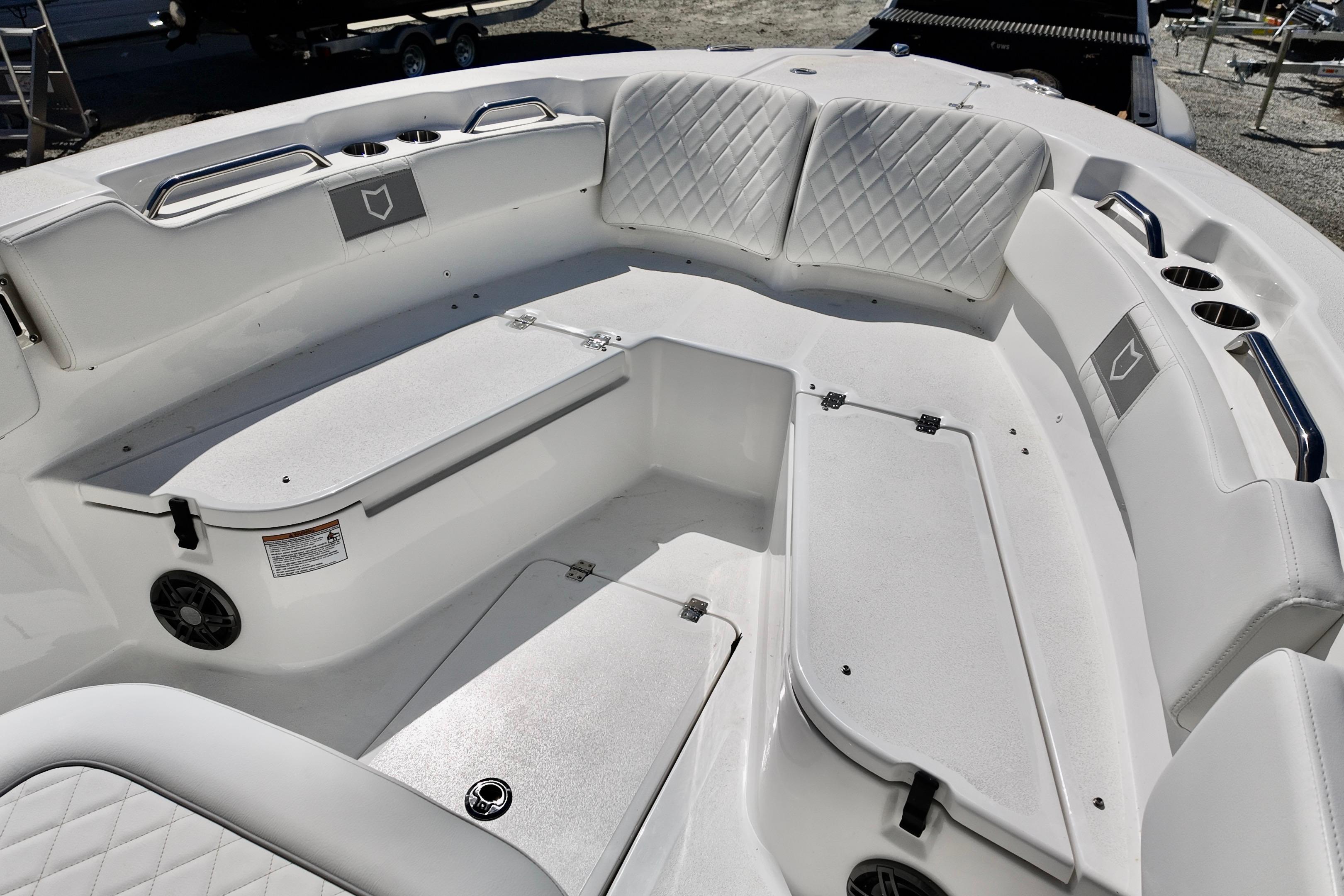 2026 Sea Fox 248 Commander boat interior with cushioned seating and storage compartments.