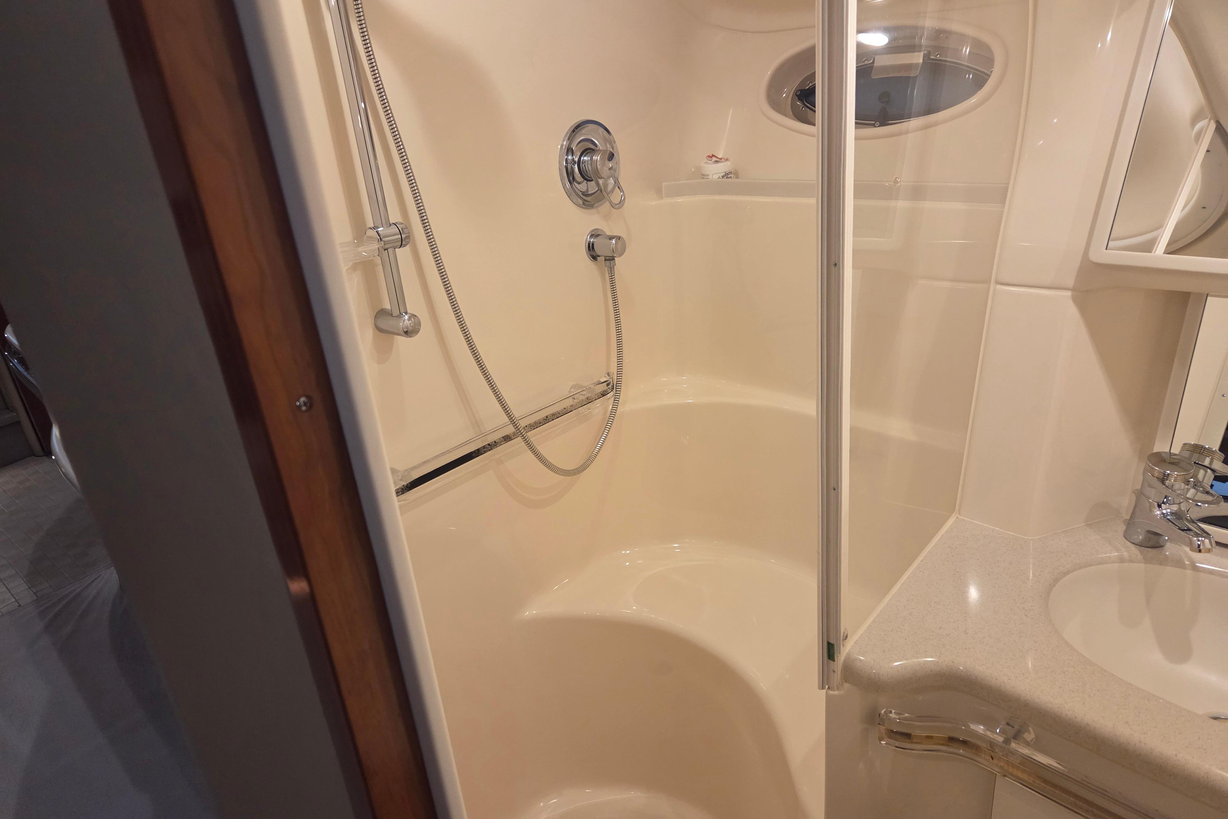 Bathroom interior of 2000 Sea Ray Sundancer 540 yacht, featuring shower and sink.