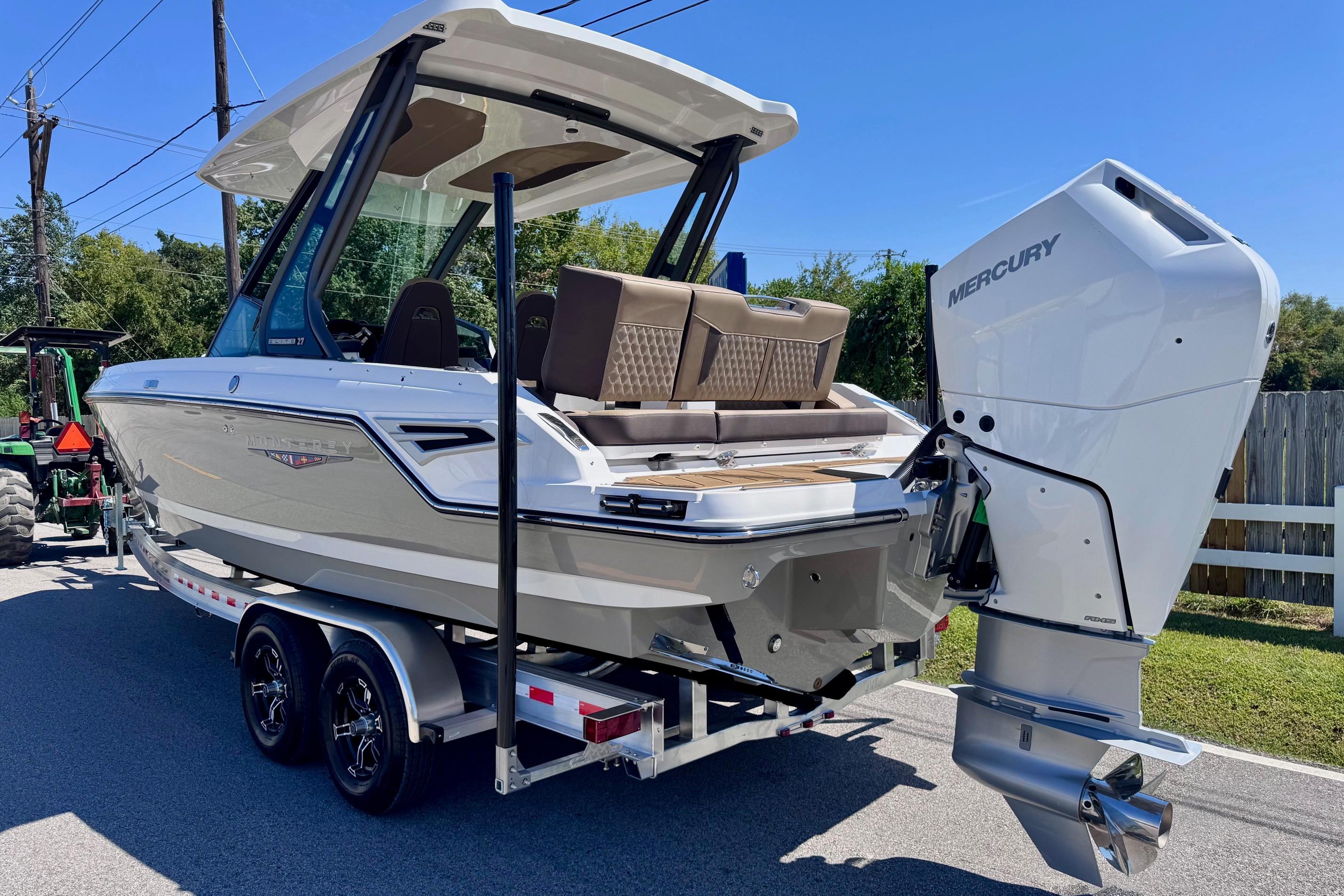 2026 Monterey Elite 27 OB boat on trailer with Mercury outboard motor.