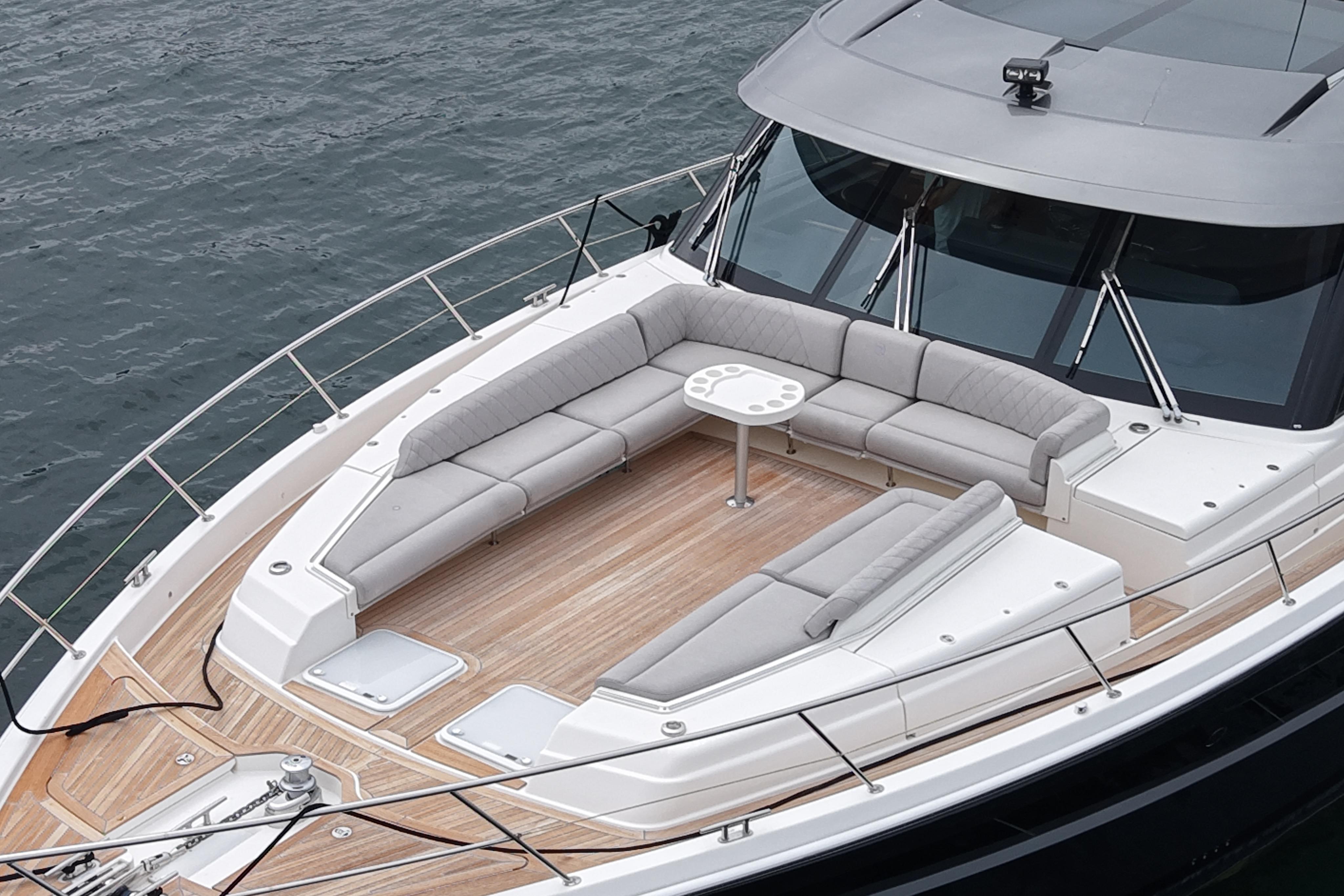Luxurious 2023 Riviera 645 SUV yacht with spacious deck seating and sleek design.