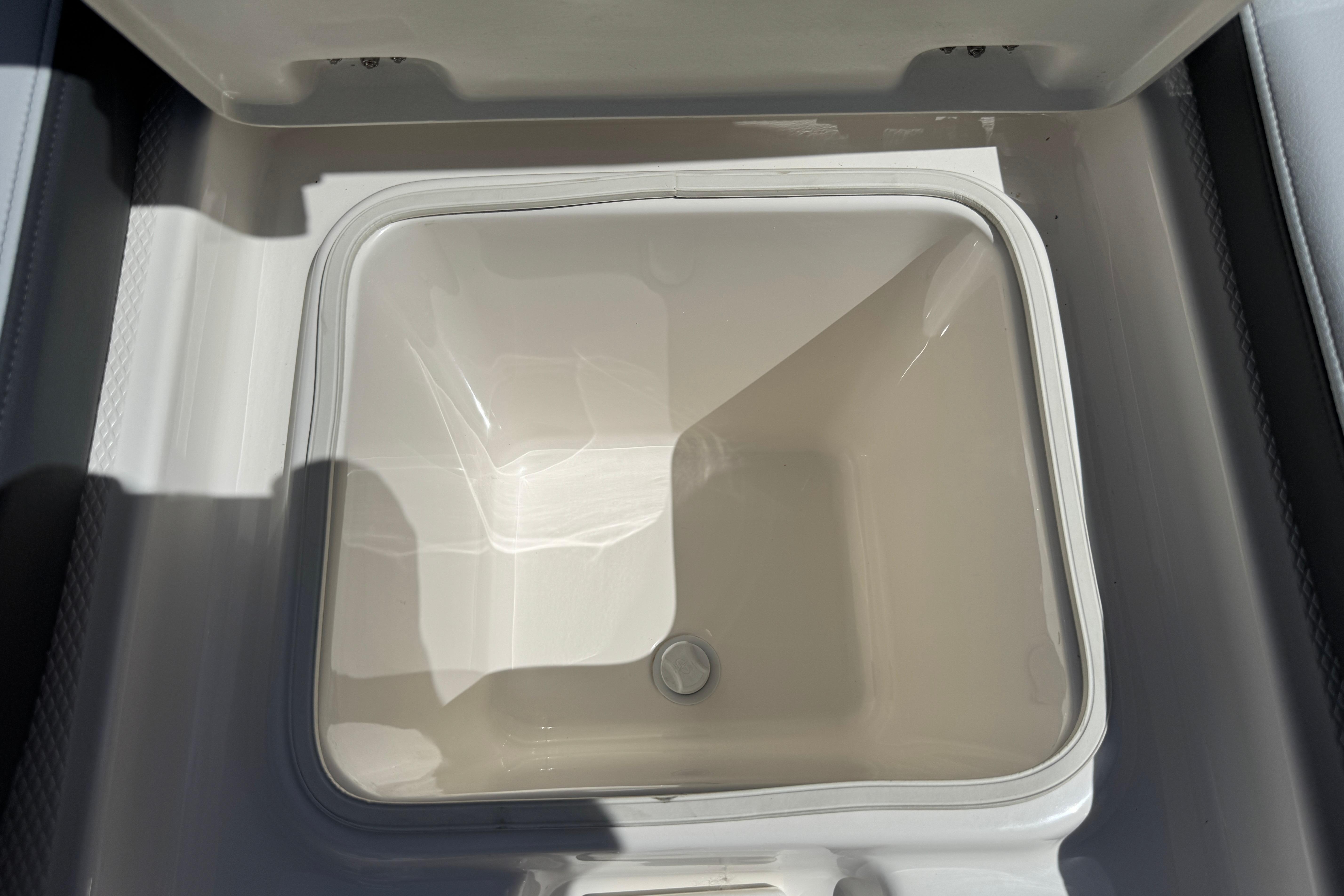 2026 Robalo R250 Center Console boat storage compartment, open and empty.