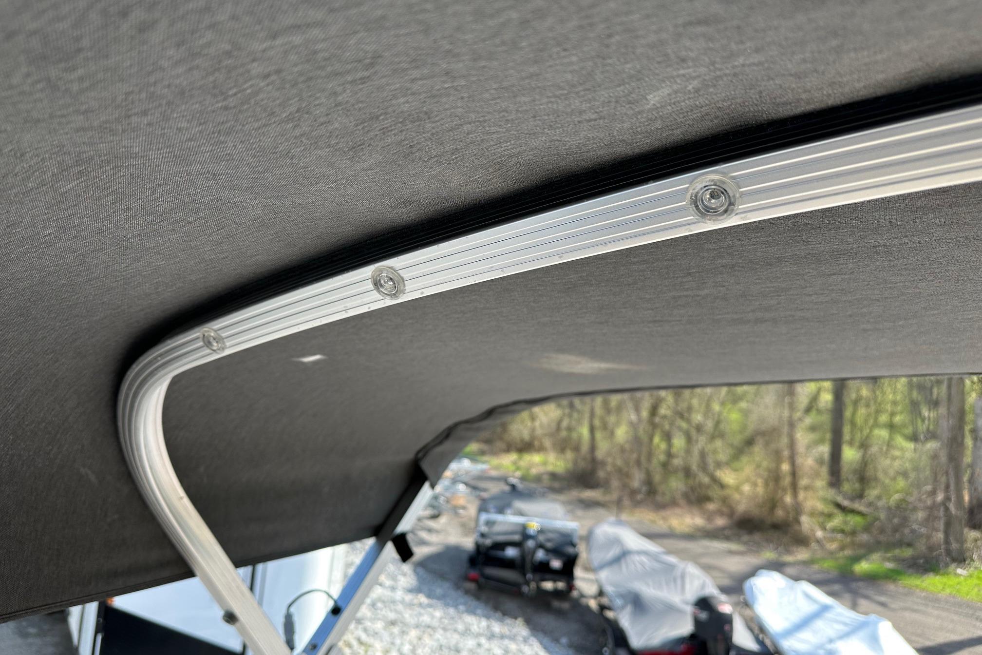 2017 Bennington 22 GPD boat canopy frame with outdoor background.