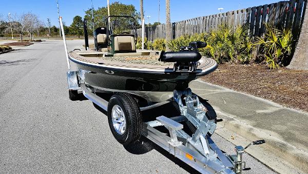 2025 Mako 18 Pro Skiff Backwater Edition on trailer, parked on a sunny street.