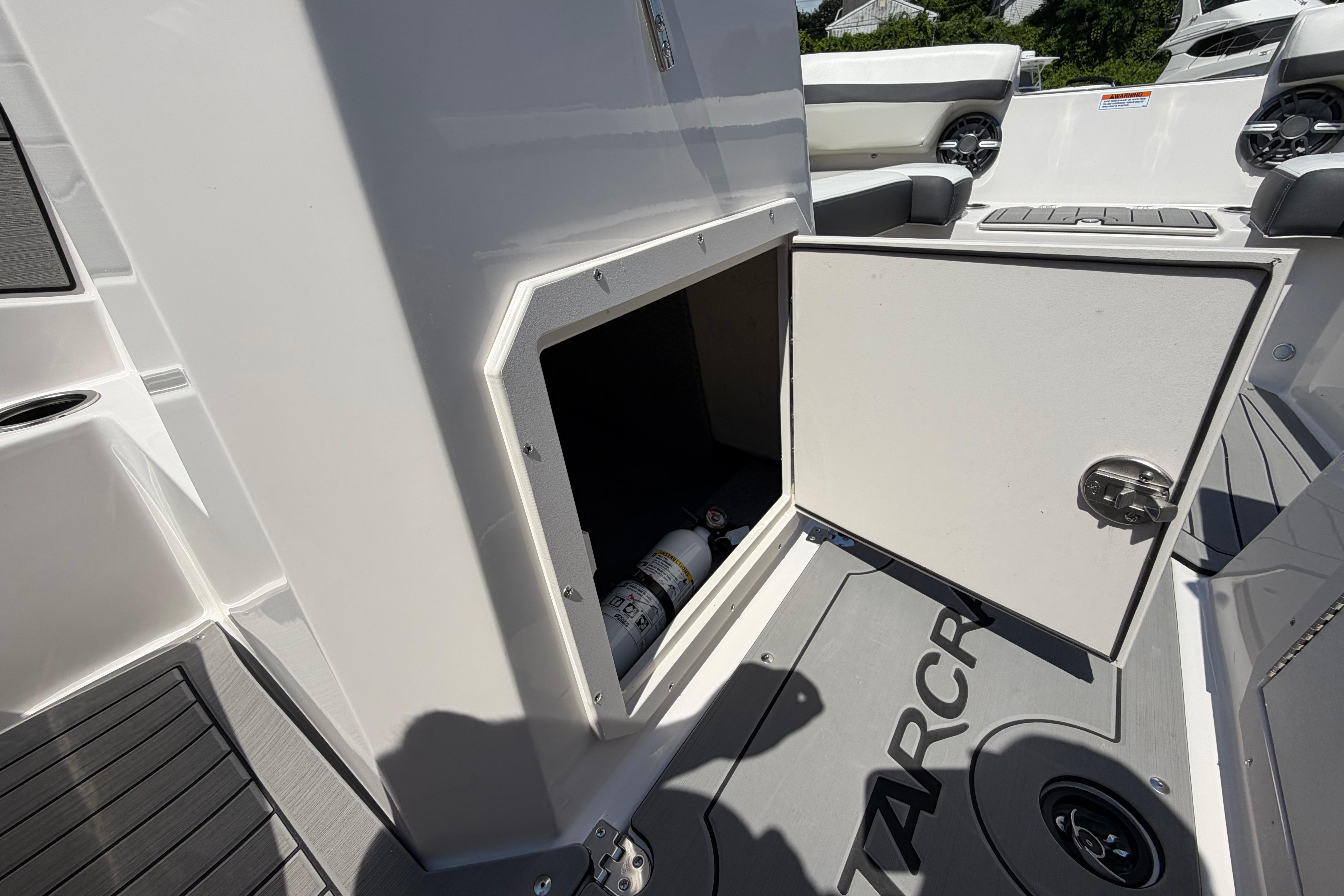 2025 Starcraft SVX 190 OB boat storage compartment with open door, revealing interior space.