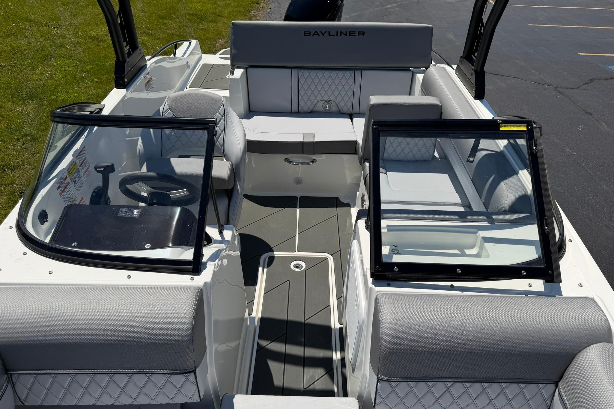 2026 Bayliner D20 boat interior with modern seating and dual windshields.