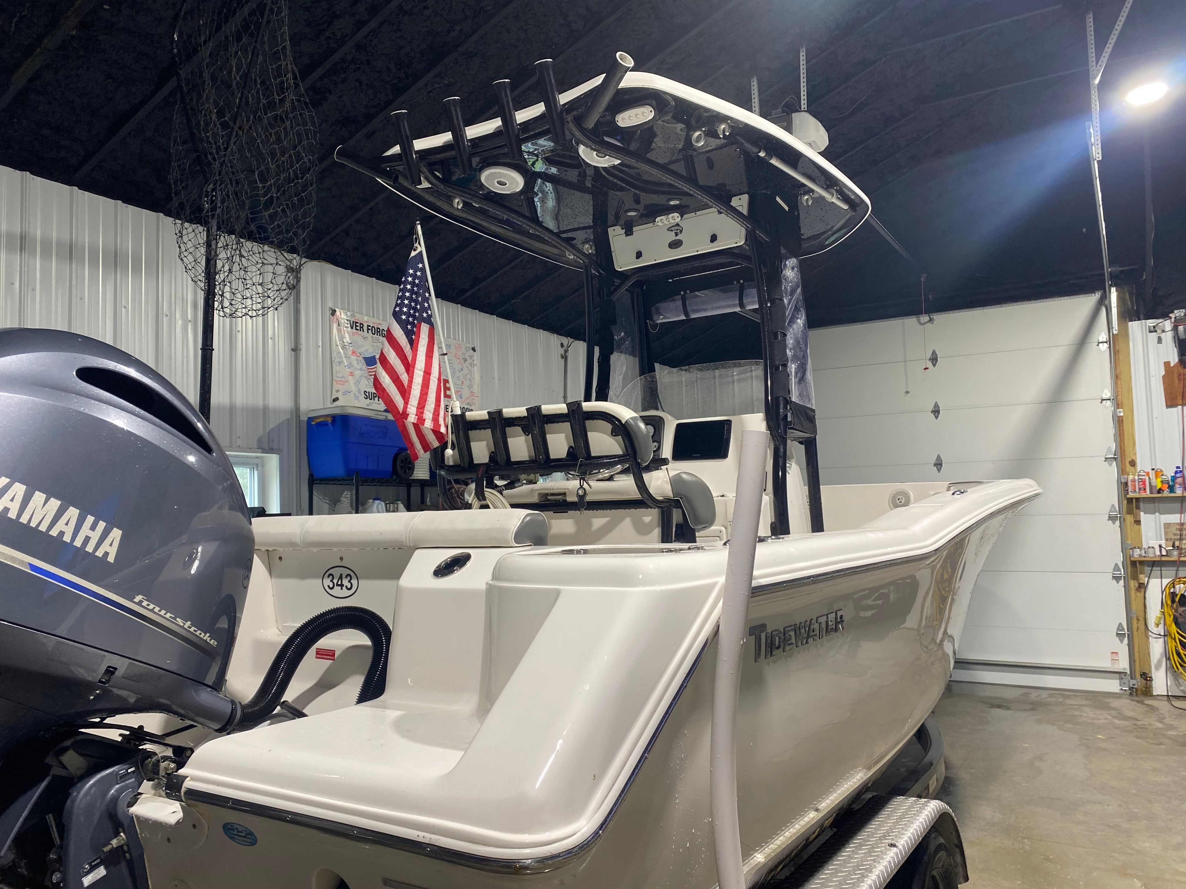 2015 Tidewater 220 CC Adventure boat in garage with Yamaha engine.