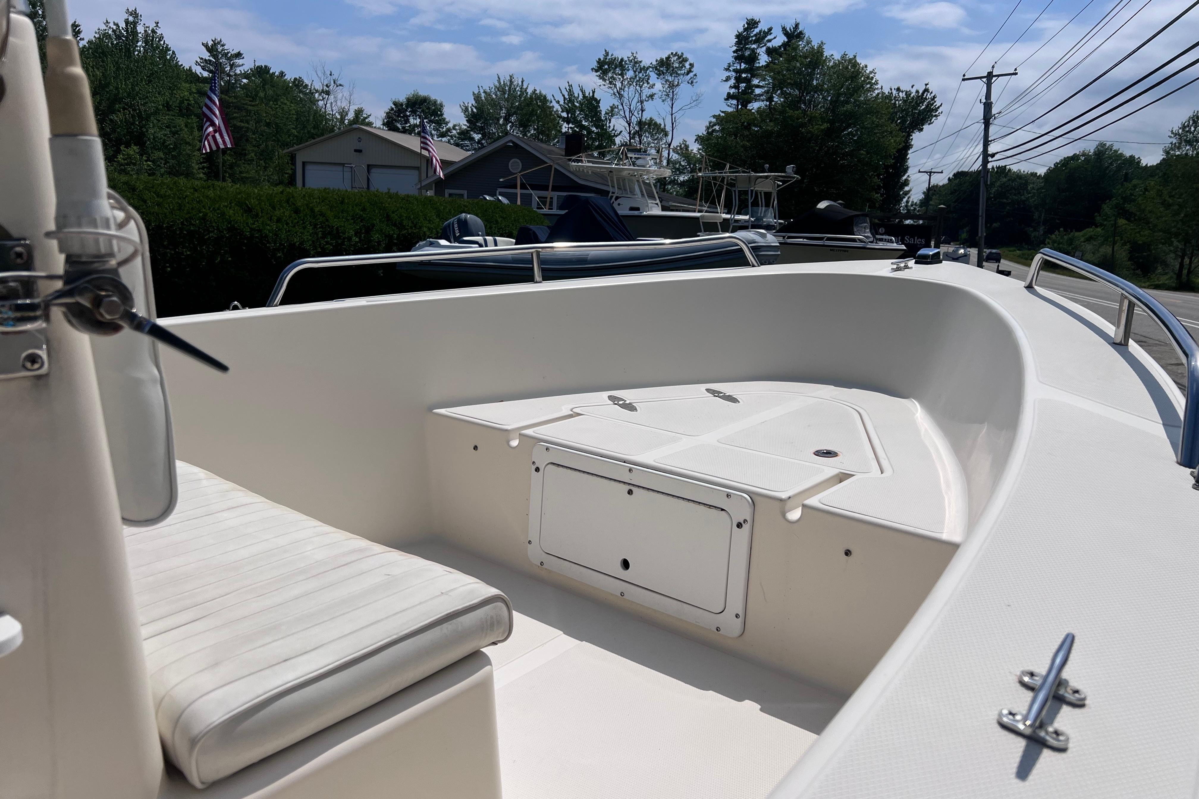 2003 May-Craft 1820CC boat interior with seating and storage, parked outdoors.