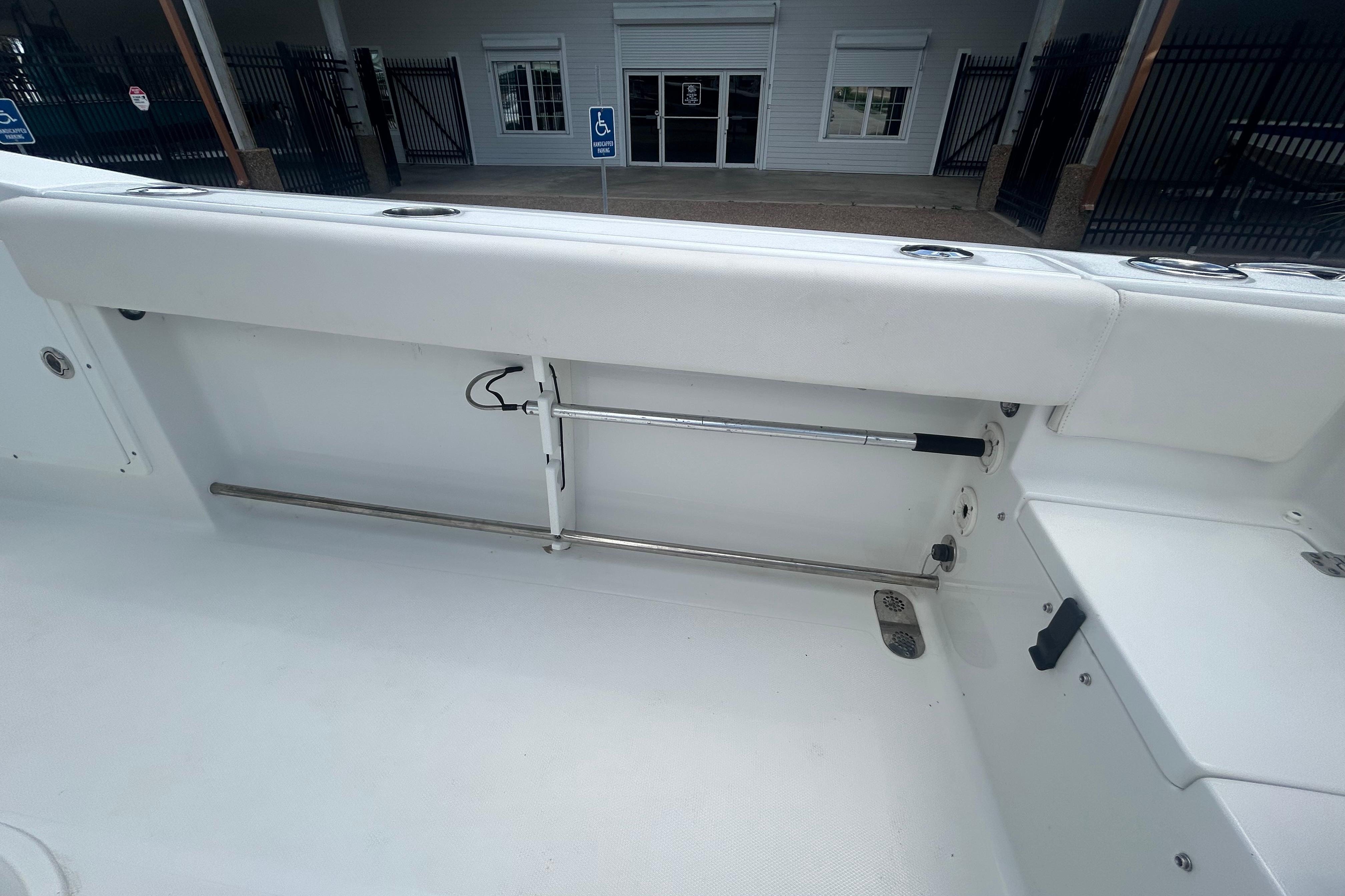 2023 Sea Hunt Gamefish 27 Coffin Box interior, showcasing sleek white seating and storage.