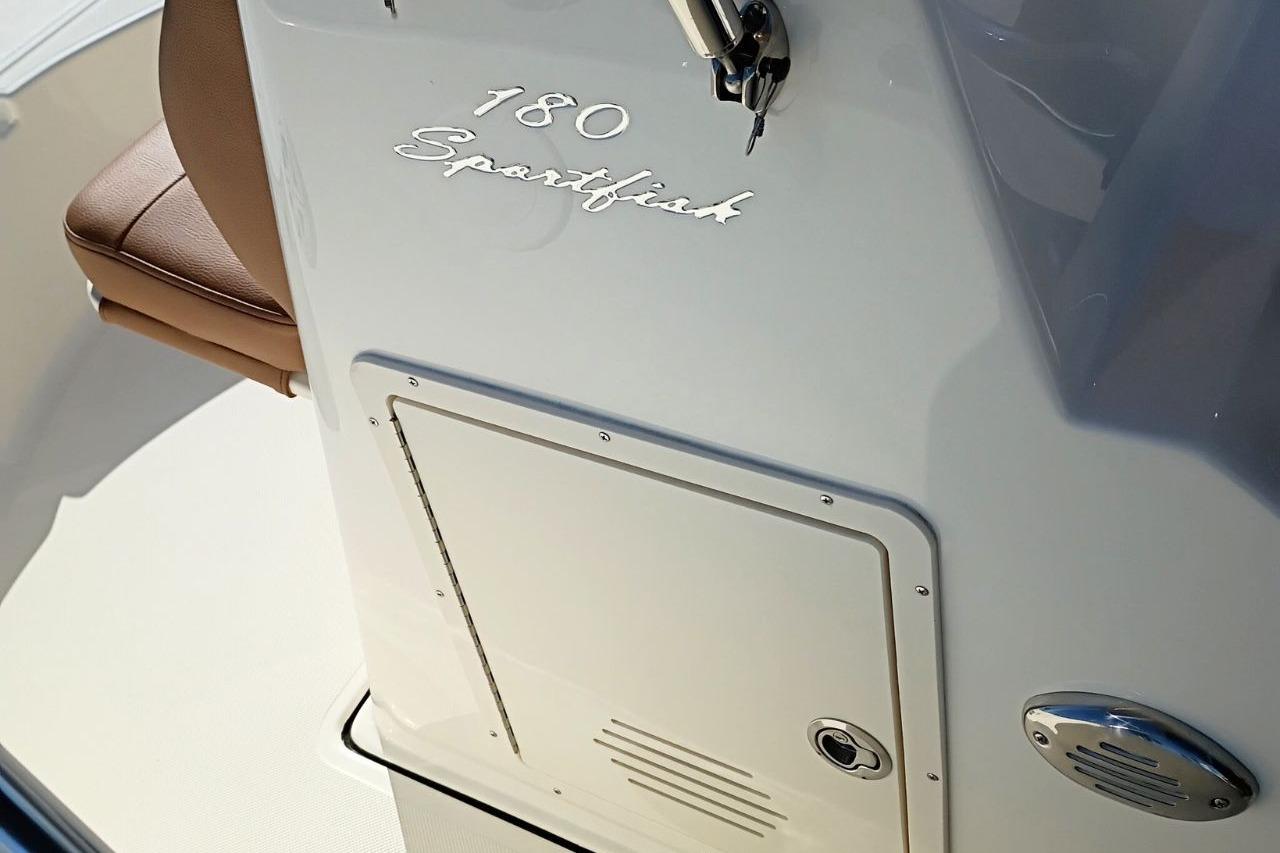 2026 Pioneer 180 Sportfish boat console with storage compartment and seating.