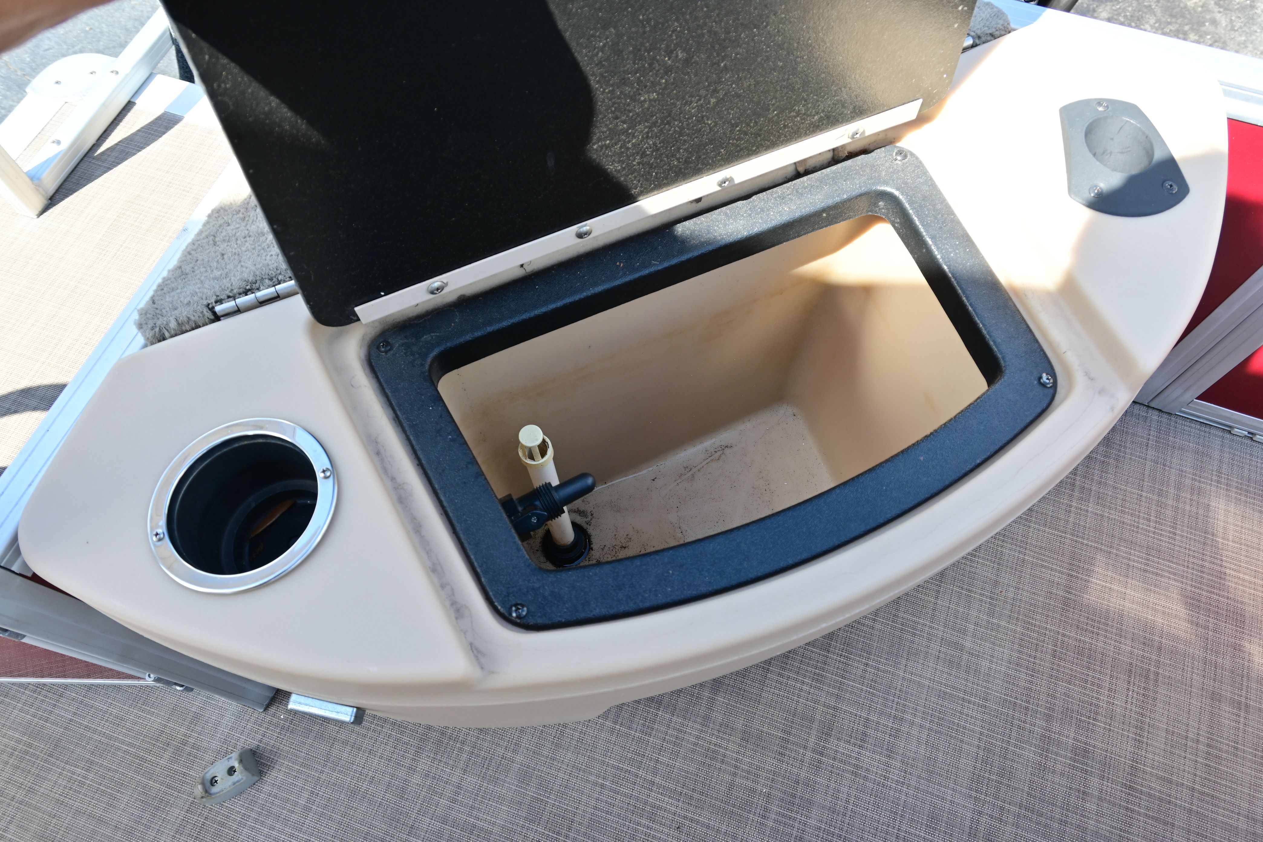 2019 Sun Tracker FISHI boat with open storage compartment.