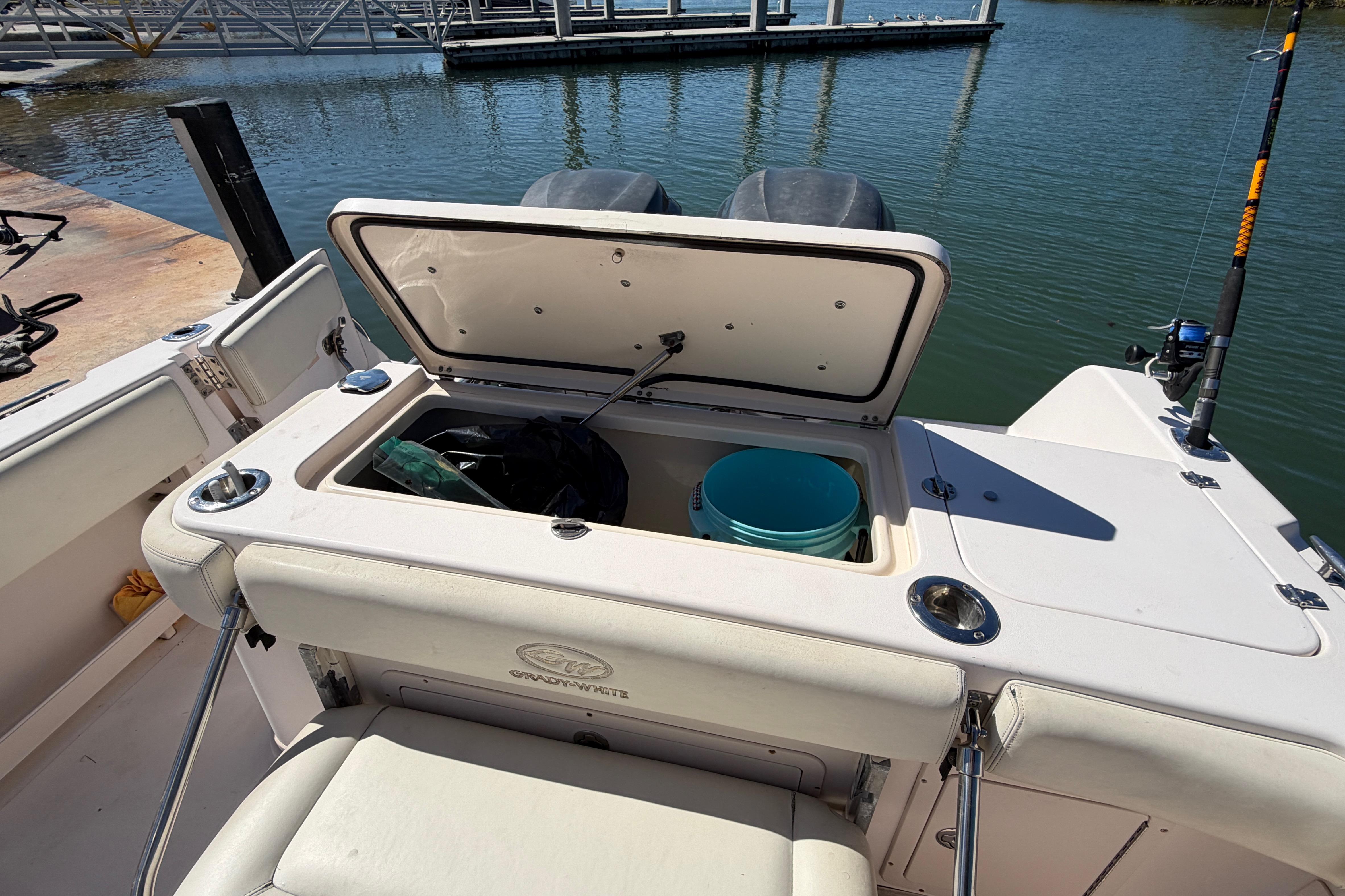 2006 Grady-White Sailfish 282 boat with open storage compartment at dockside.