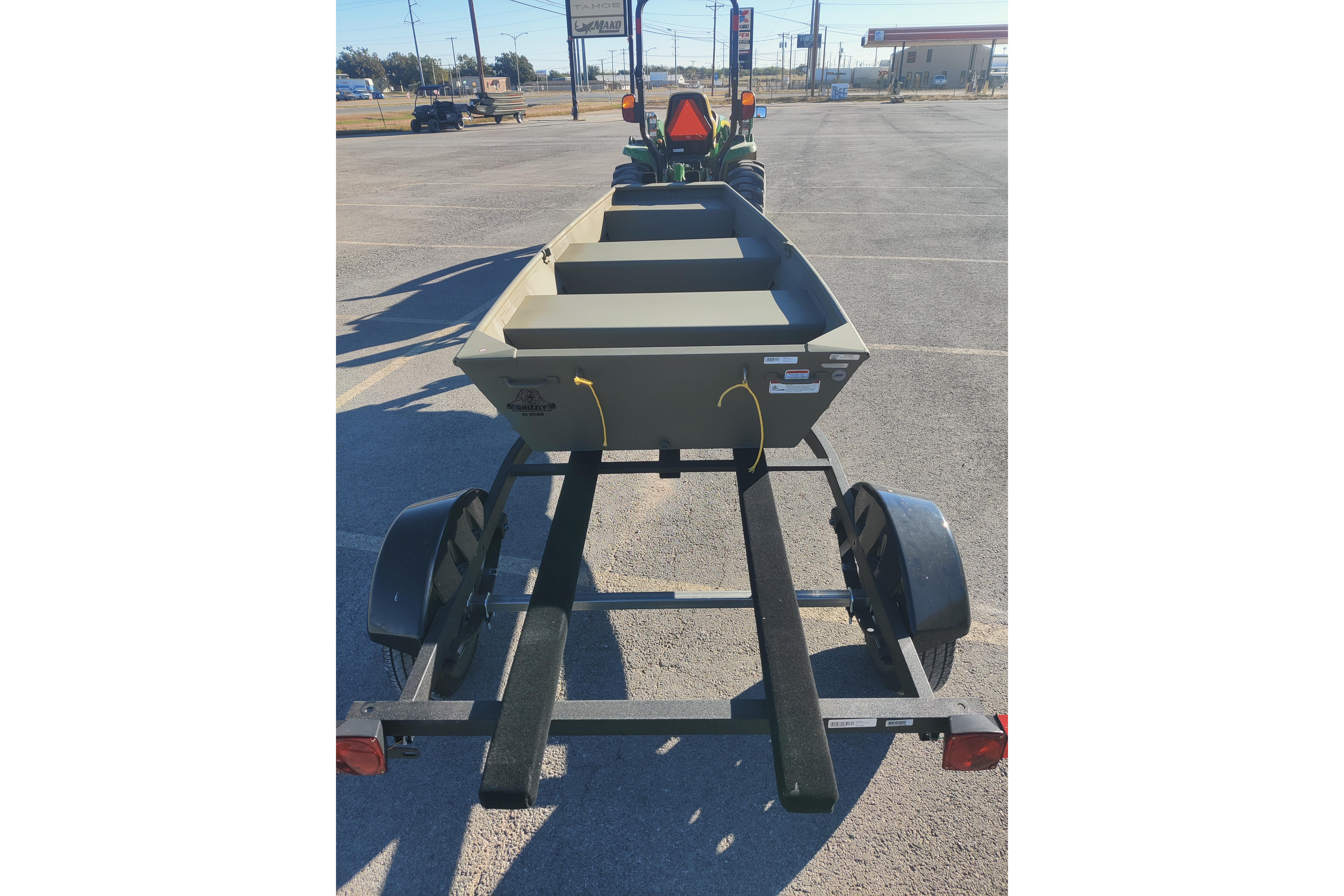 2026 Tracker Grizzly 10 Jon boat on trailer in parking lot.