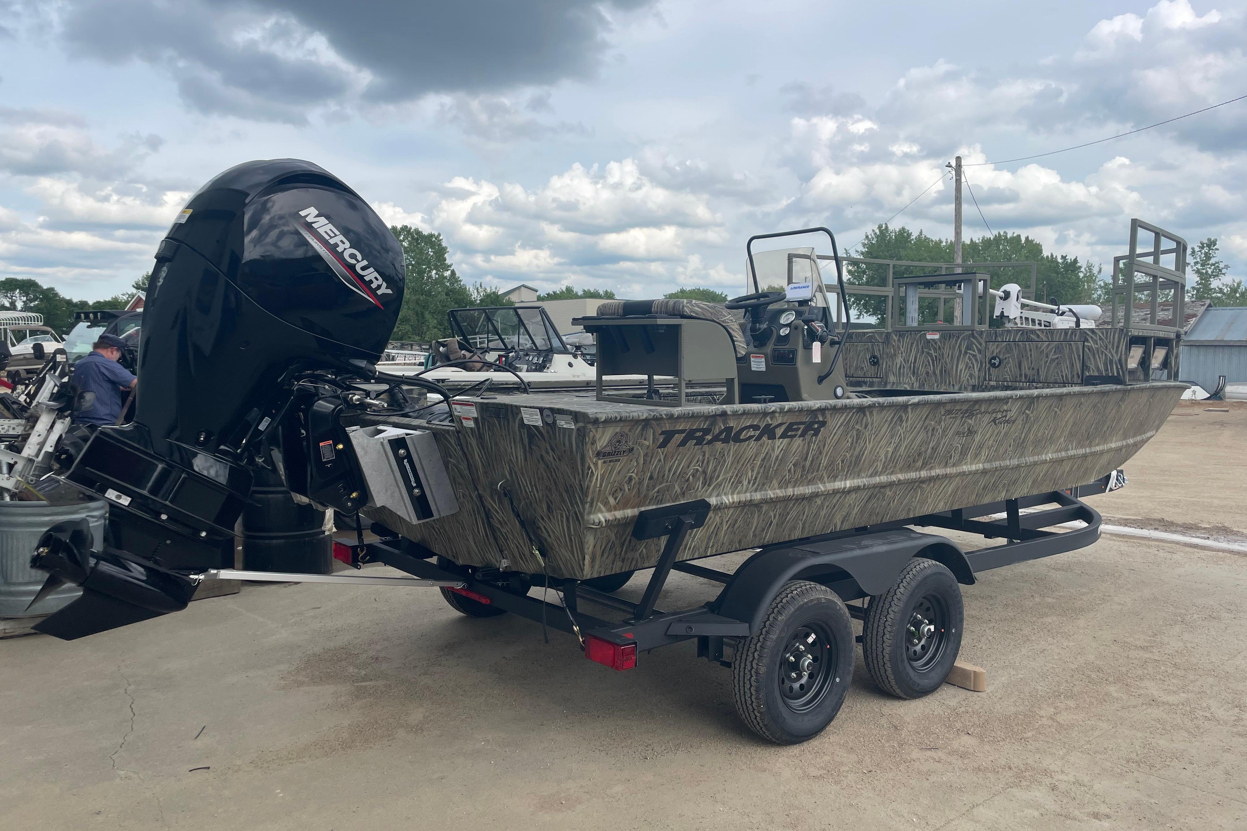 2026 Tracker Grizzly 2072 CC Sportsman Kicker boat on trailer, featuring Mercury outboard motor.