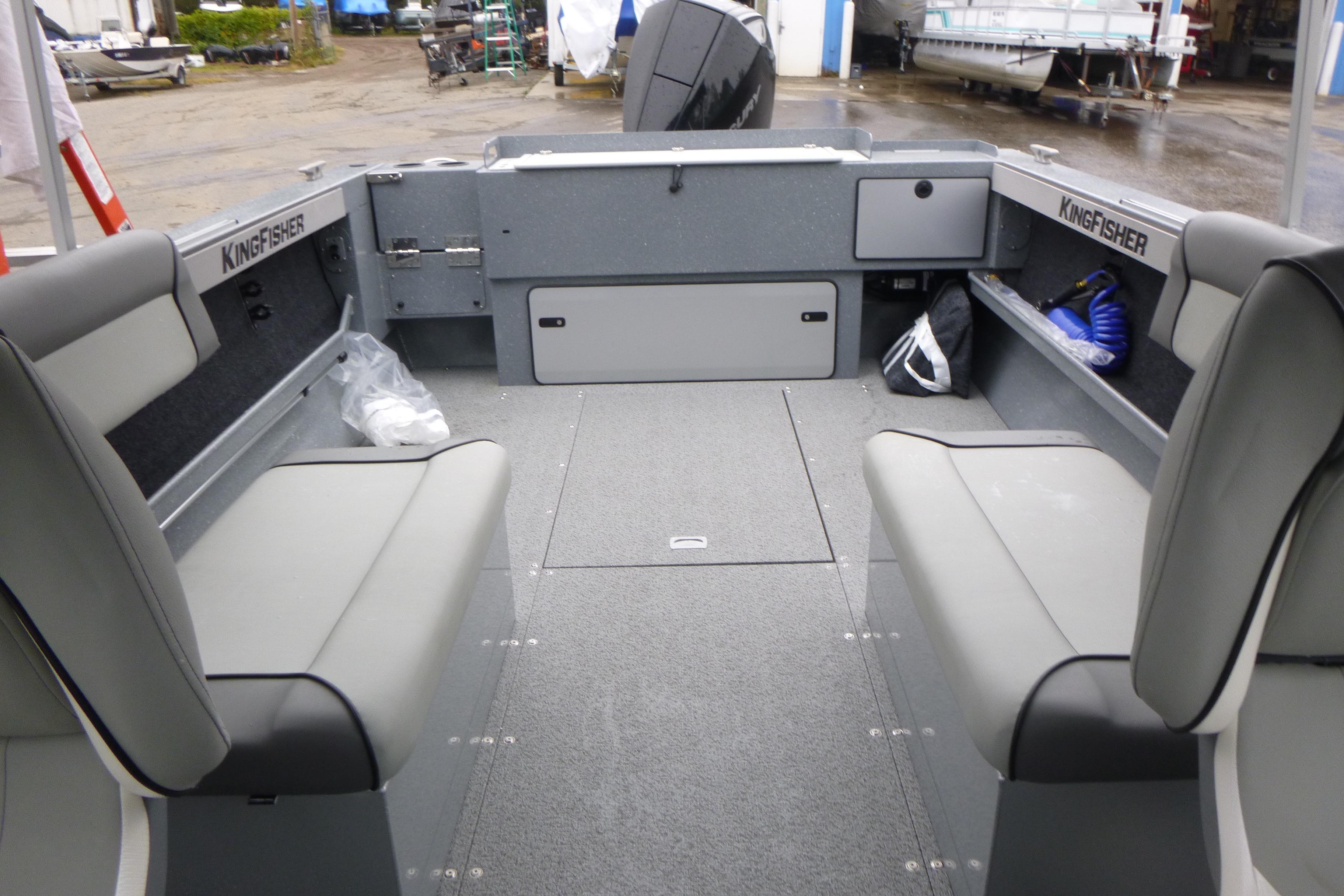 Interior of 2026 KingFisher 2025 Escape boat with gray seating and storage compartments.