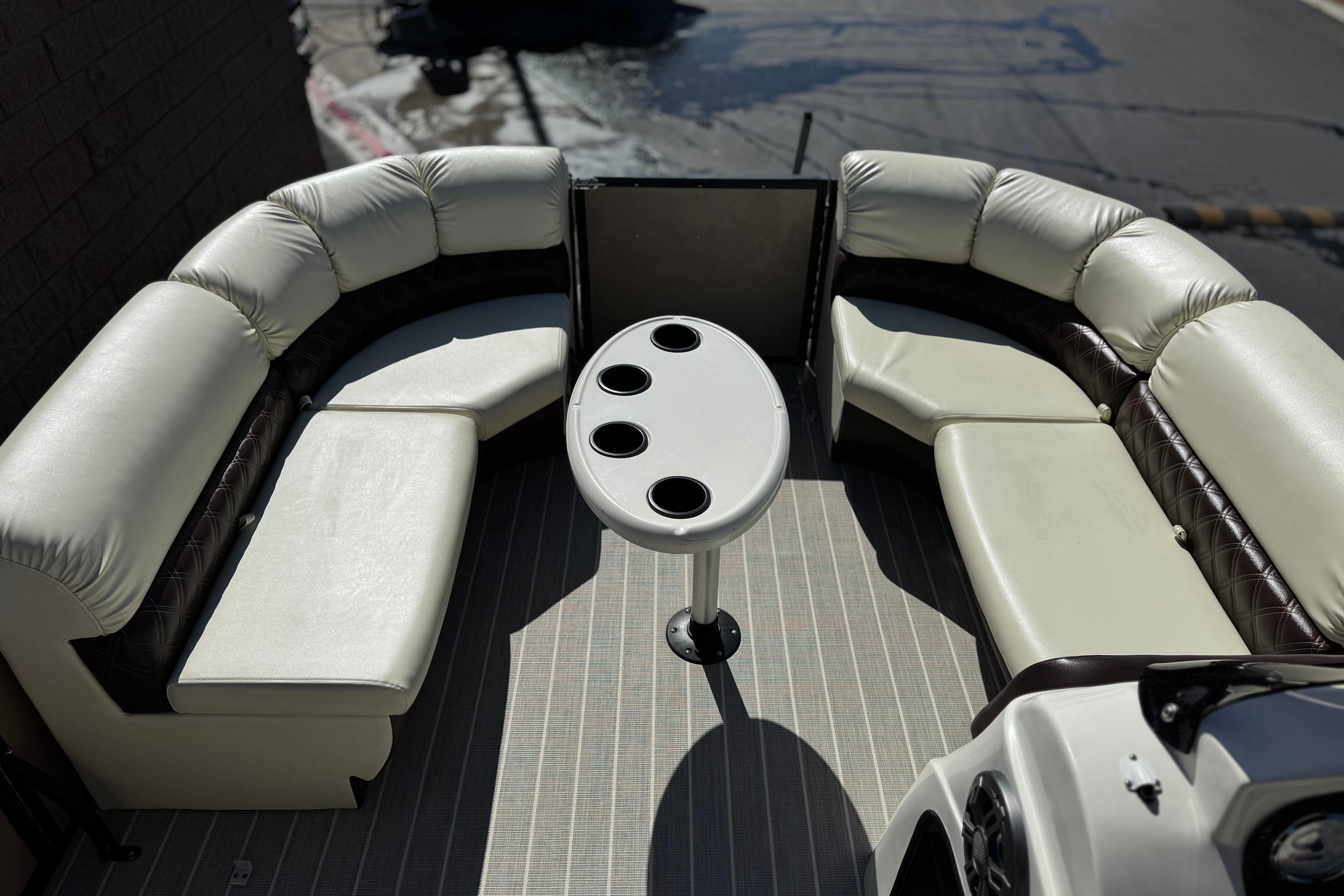 Luxurious seating area on 2023 Lexington 623 ST Xtreme boat with cupholder table.