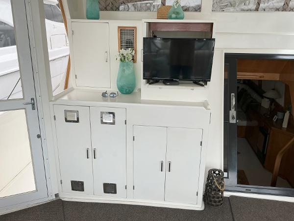 Interior of 2000 Novatec Islander 55 yacht with cabinets and mounted TV.