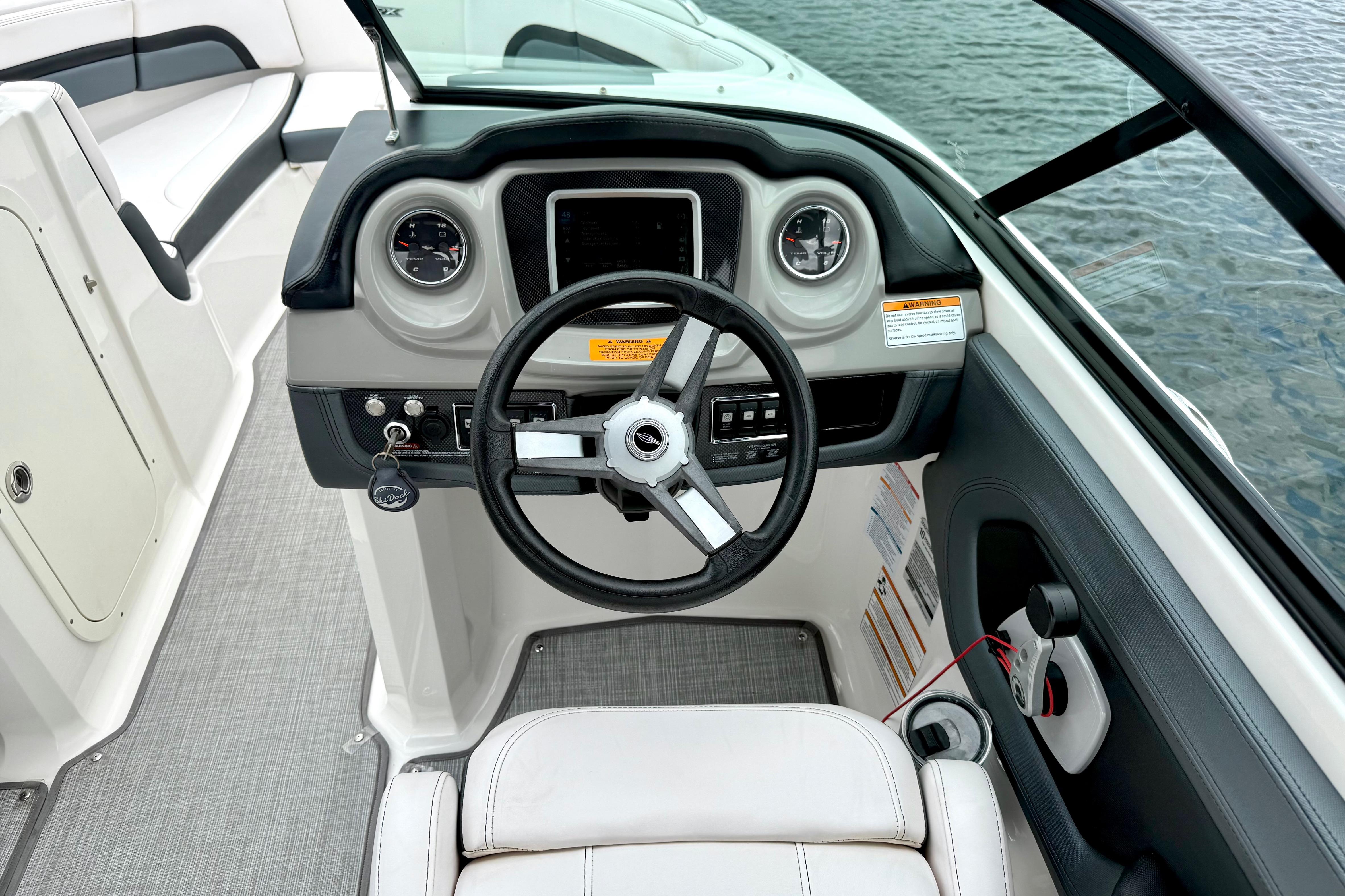 2019 Chaparral Vortex 223 VRX boat cockpit with steering wheel and dashboard controls.