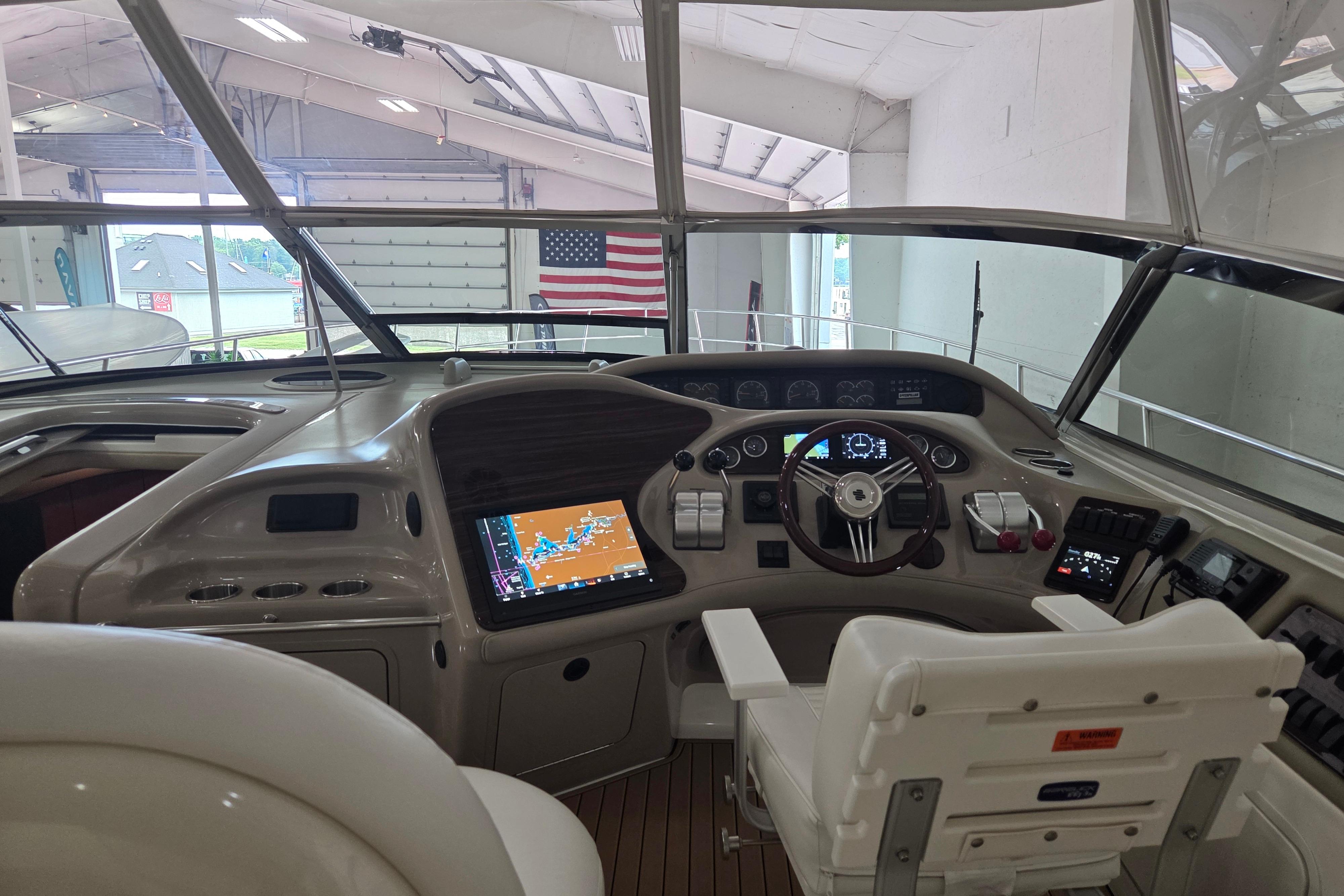 Cockpit of 2000 Sea Ray Sundancer 540 yacht with navigation equipment and American flag.