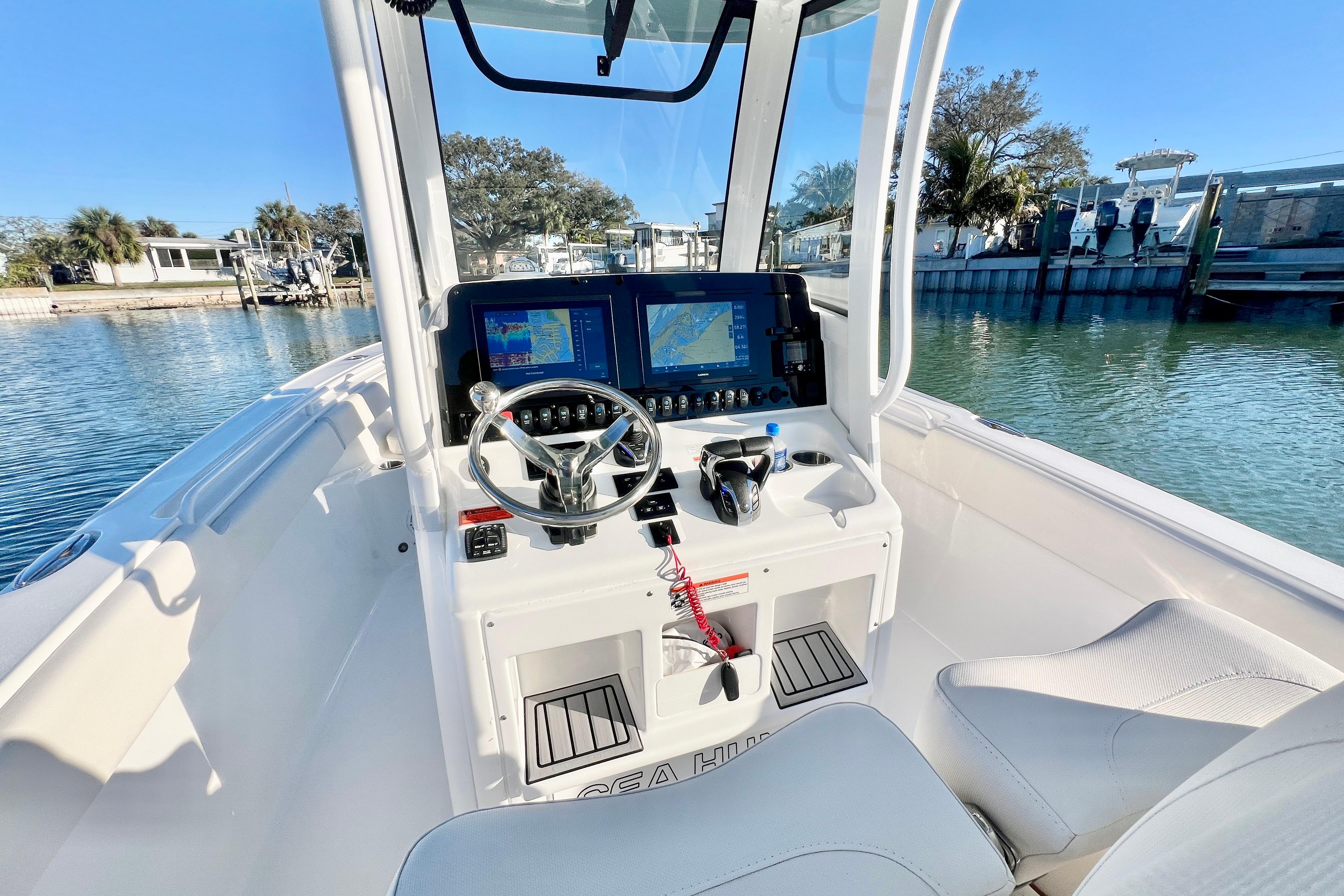 2022 Sea Hunt Ultra 265 SE boat cockpit with modern navigation system and steering wheel.