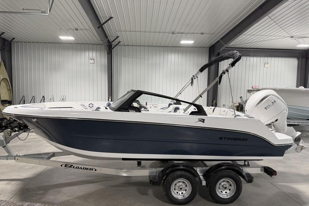 2027 Stingray 20 SBX boat on trailer in indoor storage facility.