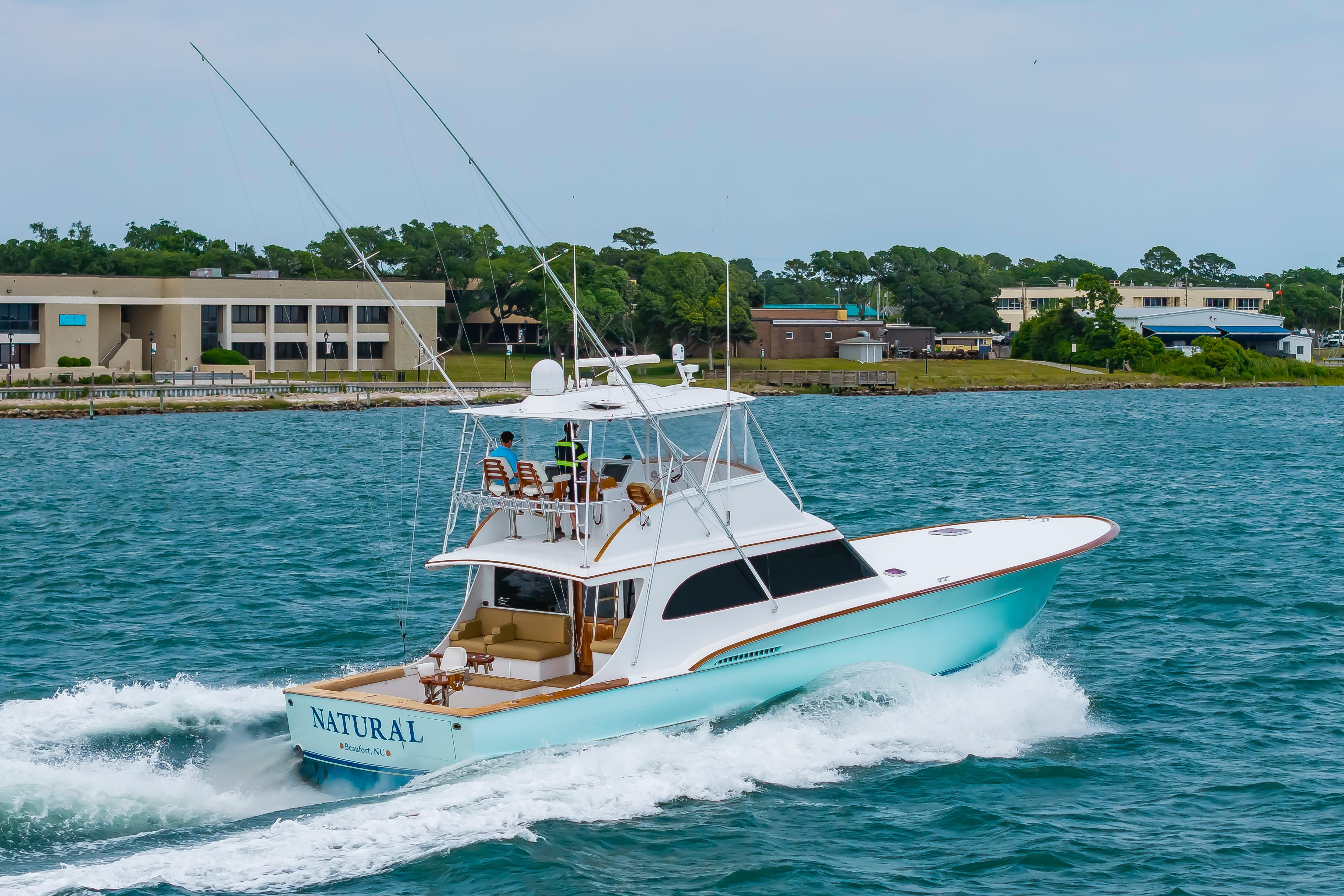 Custom Carolina Scarborough 56 Convertible yacht cruising near shoreline, 1993 model.