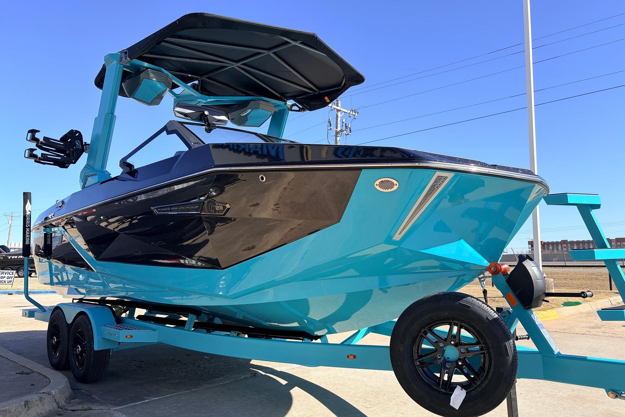 2026 Nautique Super Air Nautique G23 boat in vibrant blue on trailer.