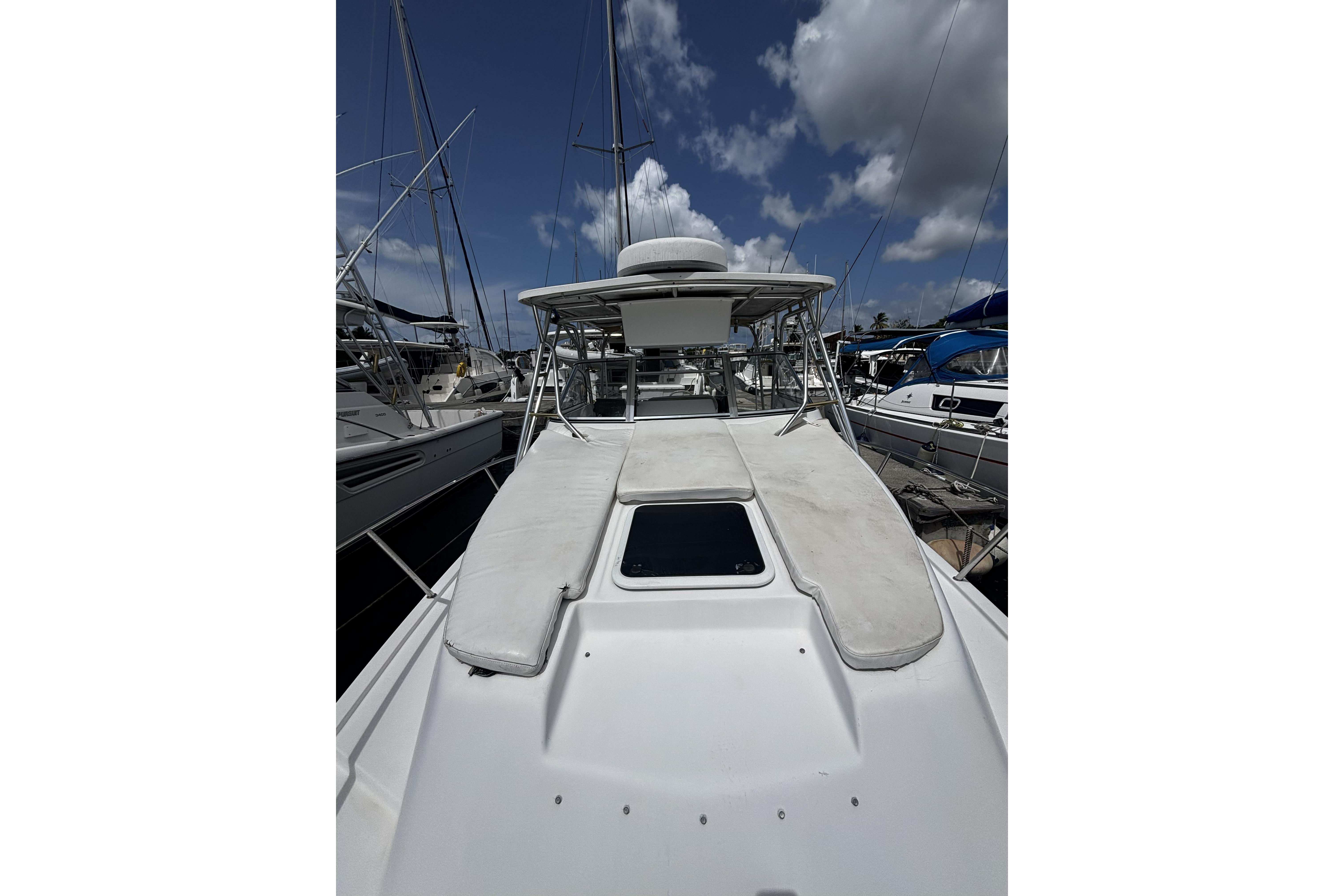 2005 Prosports 2860 KATWA boat docked under a partly cloudy sky.