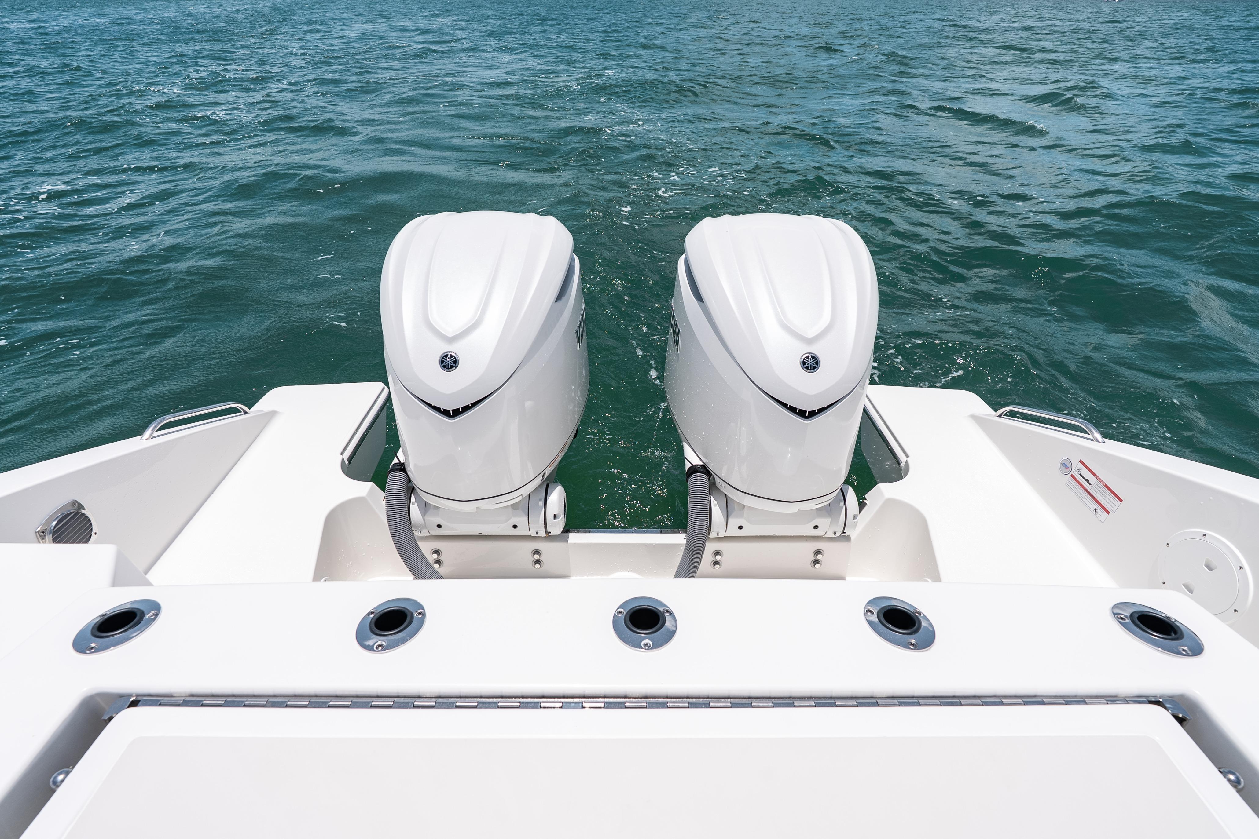 2026 Pursuit DC 326 Dual Console boat with twin outboard engines on open water.