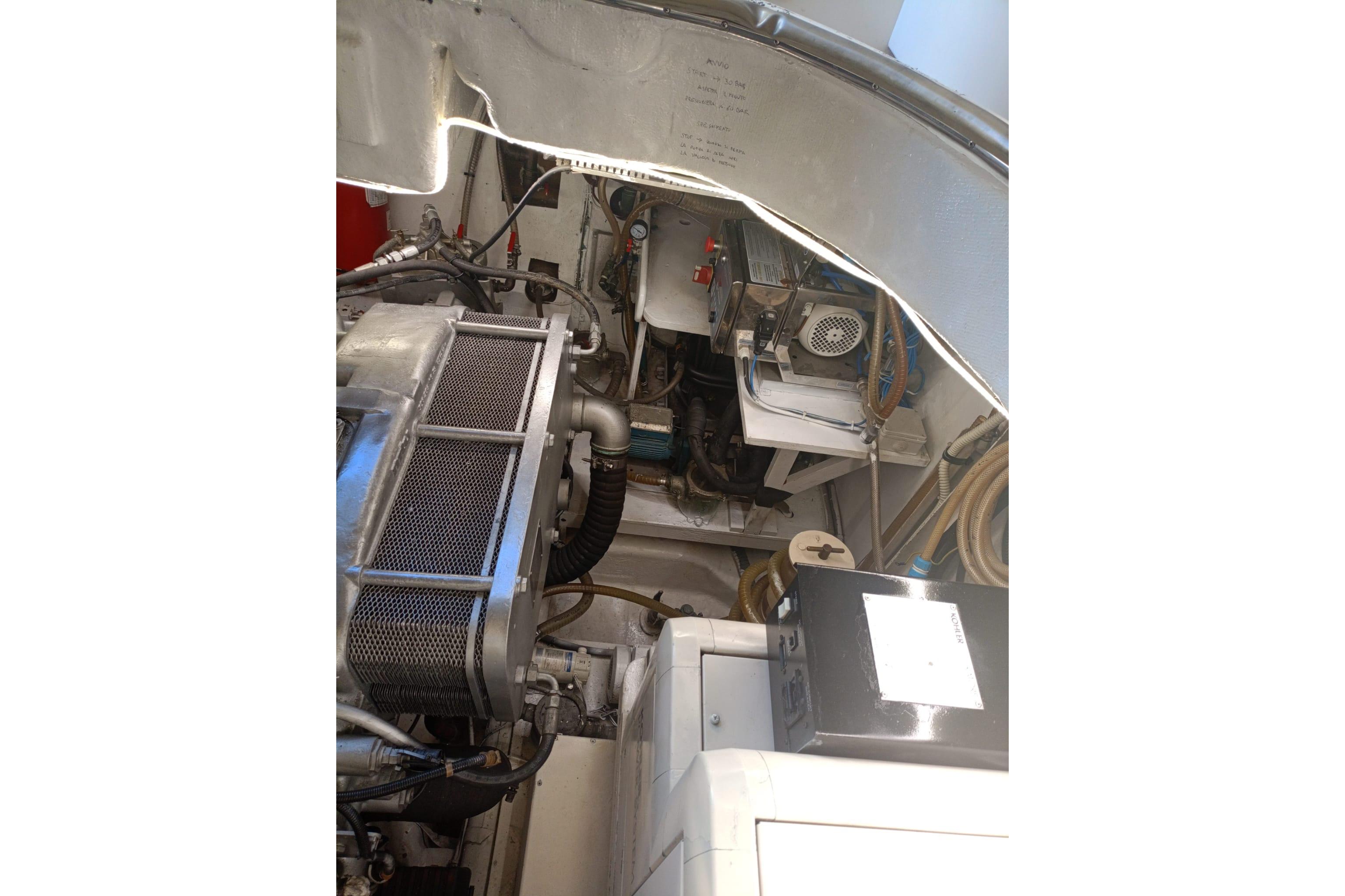 Engine room of 2001 Baia Azzurra 63 yacht, showcasing mechanical components and wiring.
