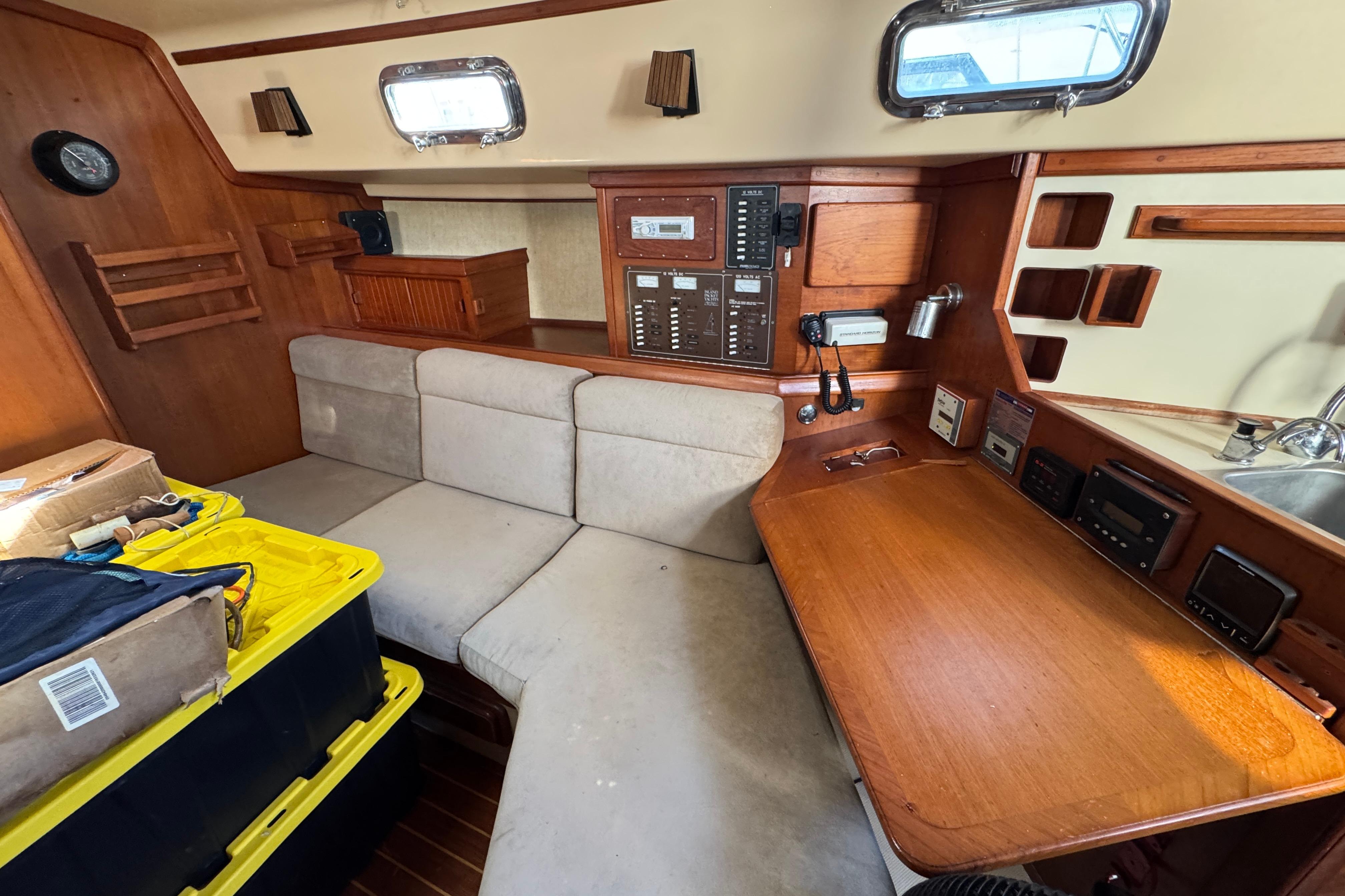 Interior of 1991 Island Packet Yachts 38 with navigation station and seating area.