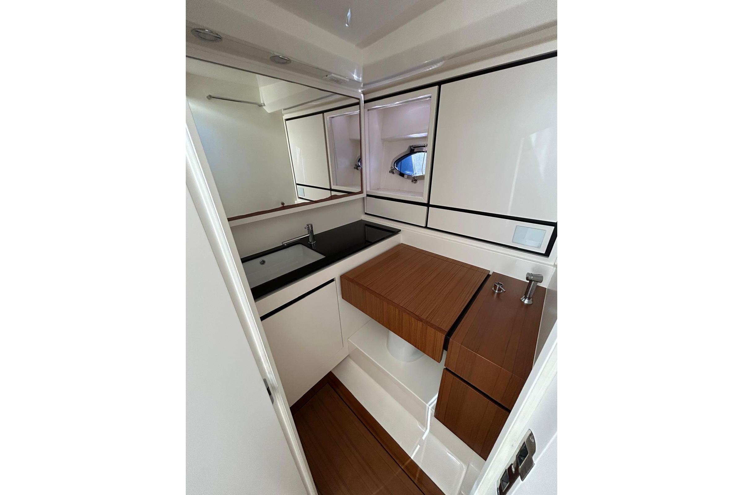 Luxurious bathroom interior of 2019 Itama 45s yacht with modern fixtures and wood accents.