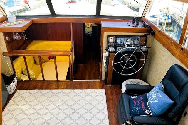 Interior of a 1980 Viking 43 Convertible yacht with helm, seating, and cozy cabin area.