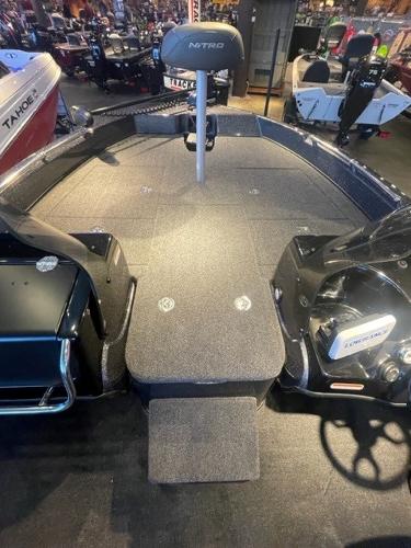 2025 Nitro ZV19 boat interior with seating and steering wheel in showroom.