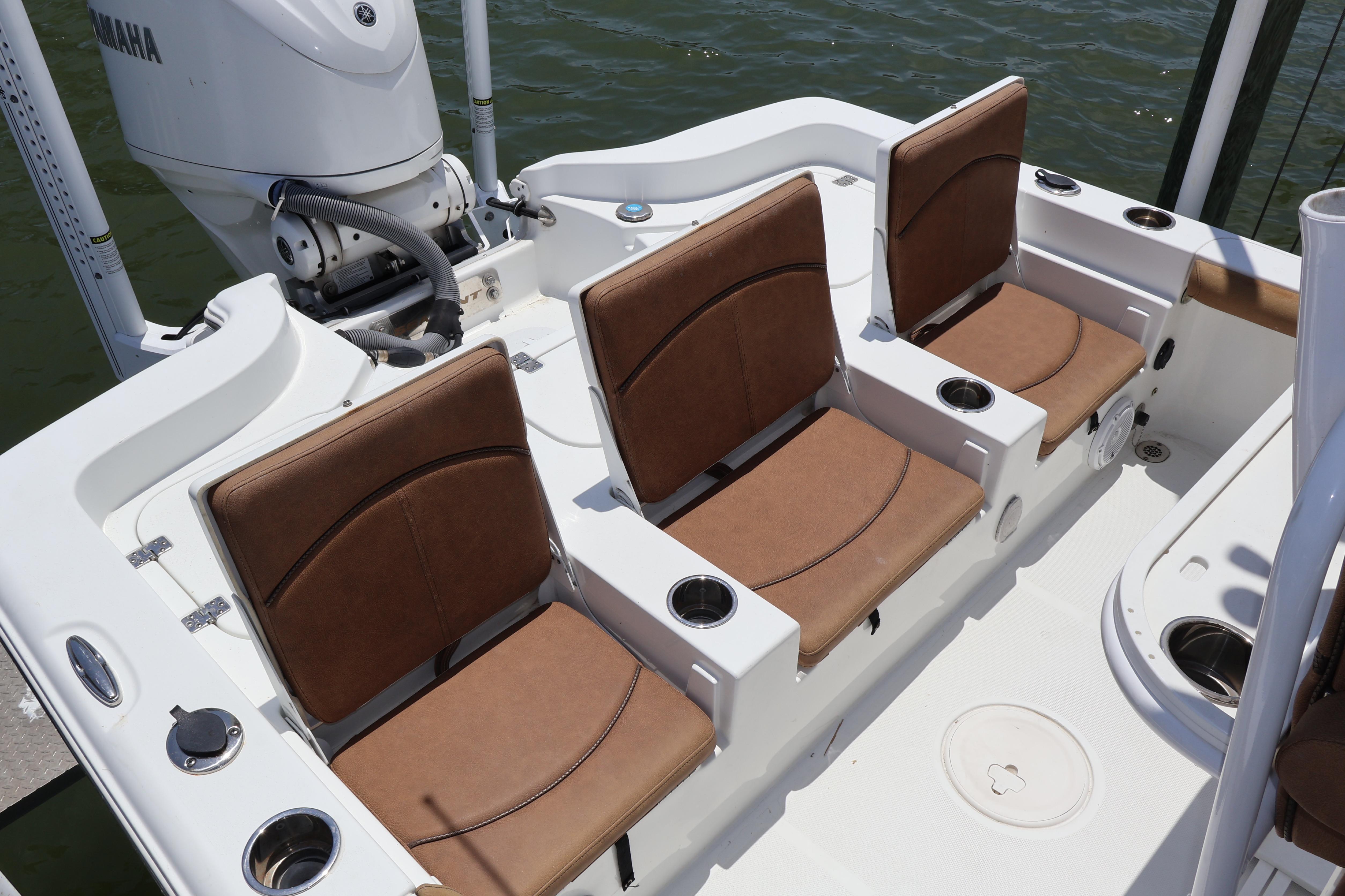 2022 Sea Hunt BX 25 FS boat interior with brown cushioned seats and cup holders.