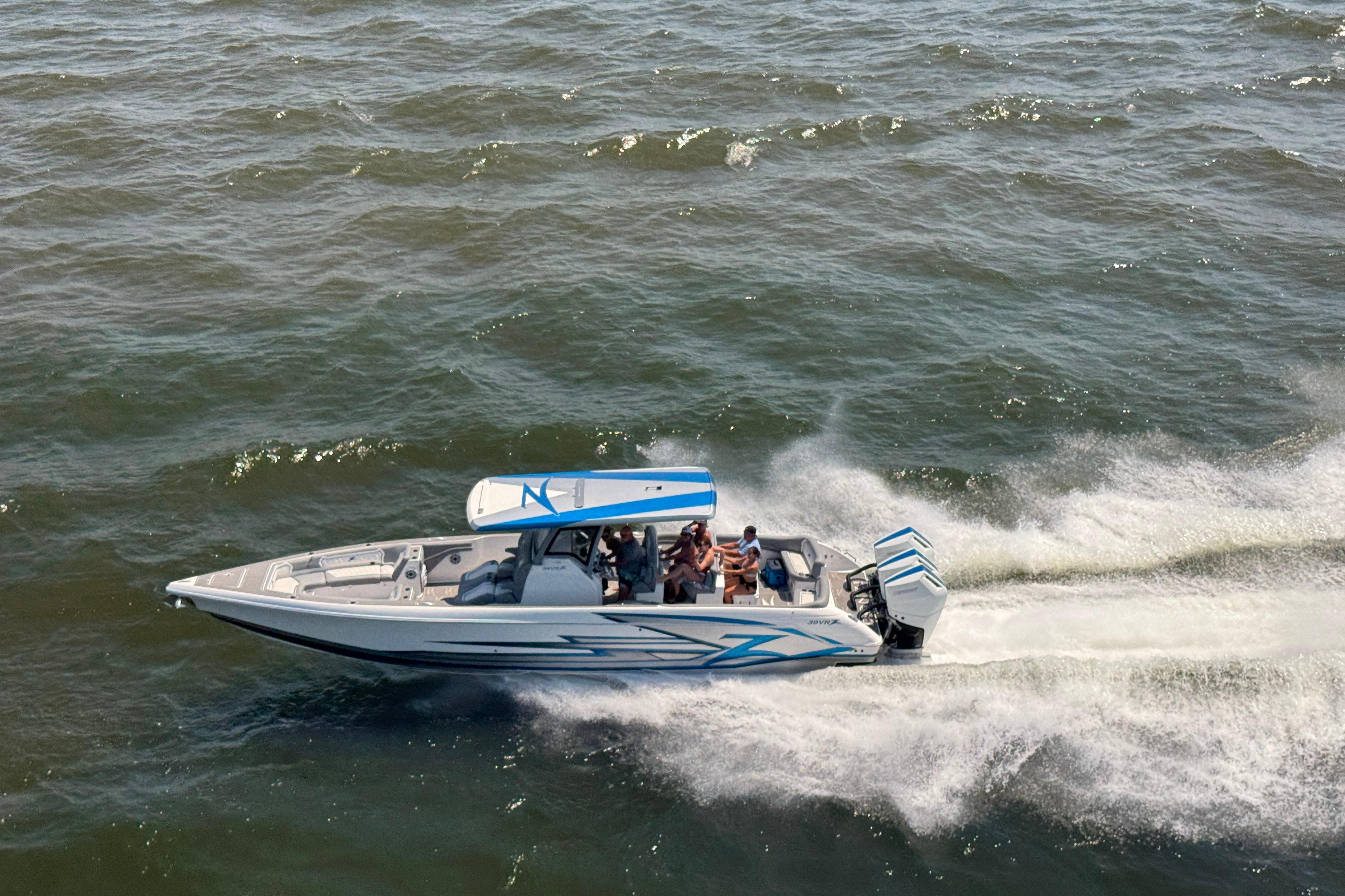 2024 Donzi 39 VRZ speedboat cruising on open water, showcasing sleek design and performance.