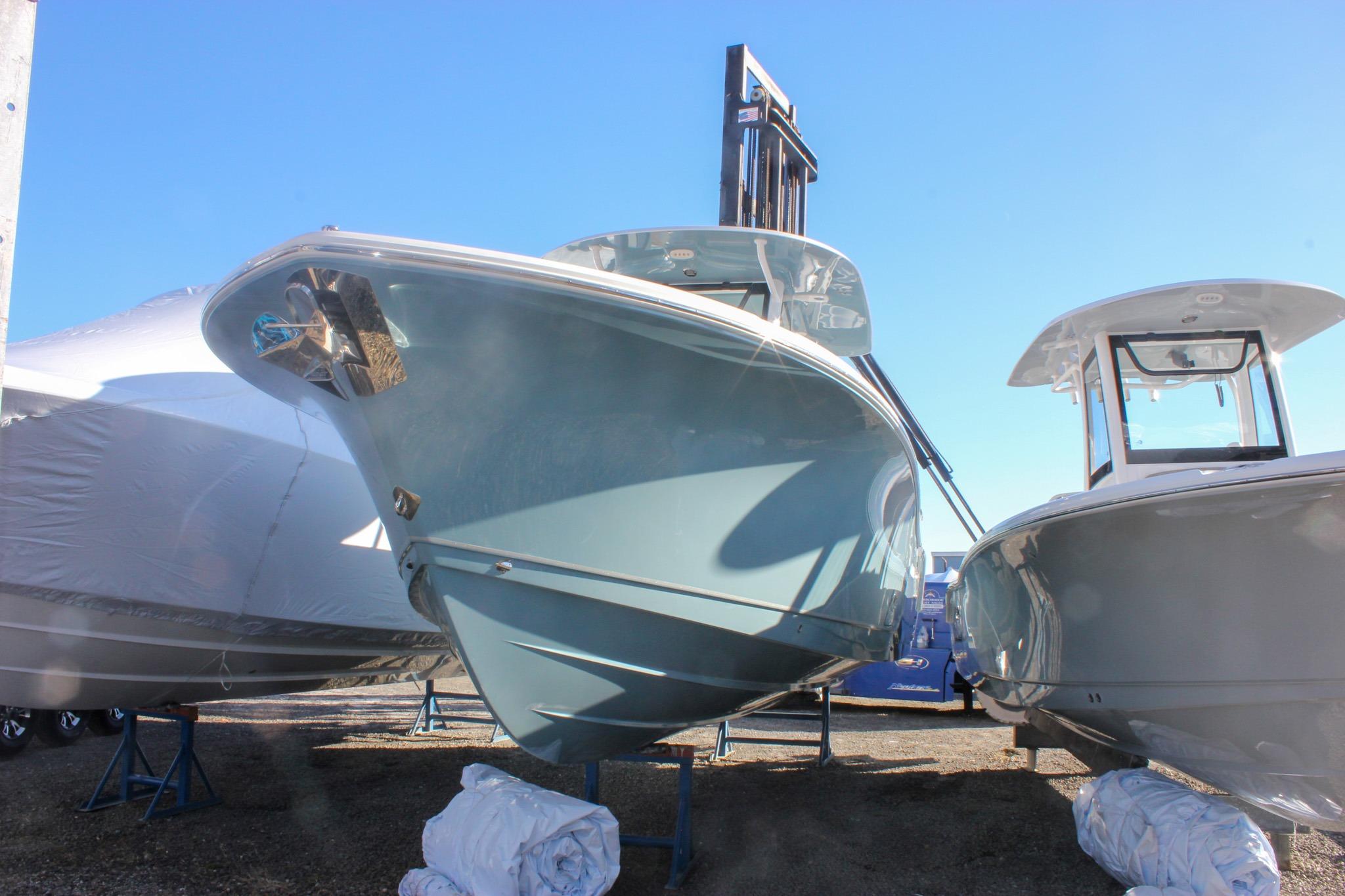 2026 Sea Hunt Ultra 285 SE boat displayed outdoors under clear blue sky.