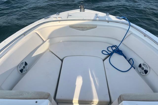 2016 Robalo R247 Dual Console boat interior with seating and blue rope on water.