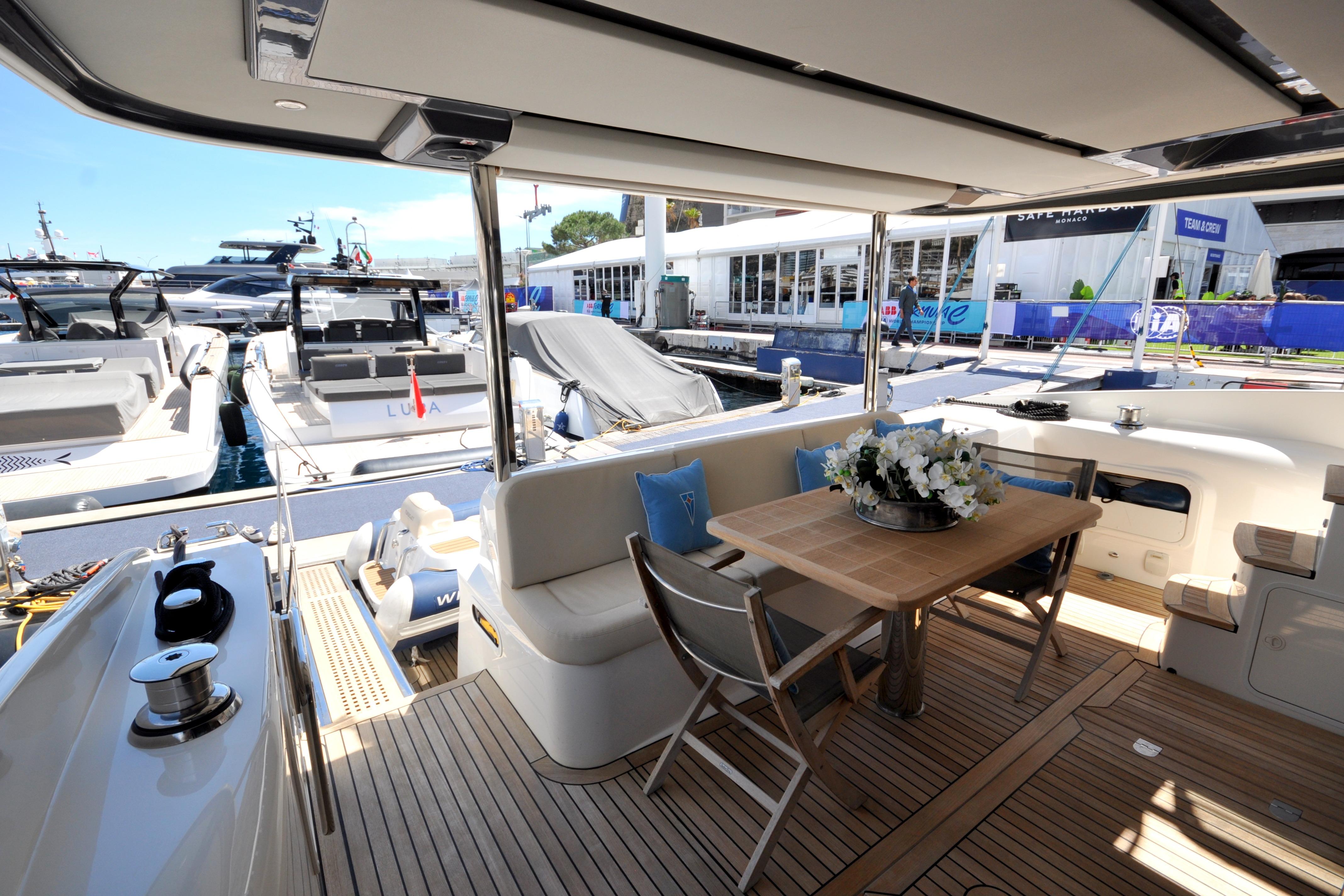 Luxurious 2018 Absolute Navetta 52 yacht interior with elegant seating and dining area.