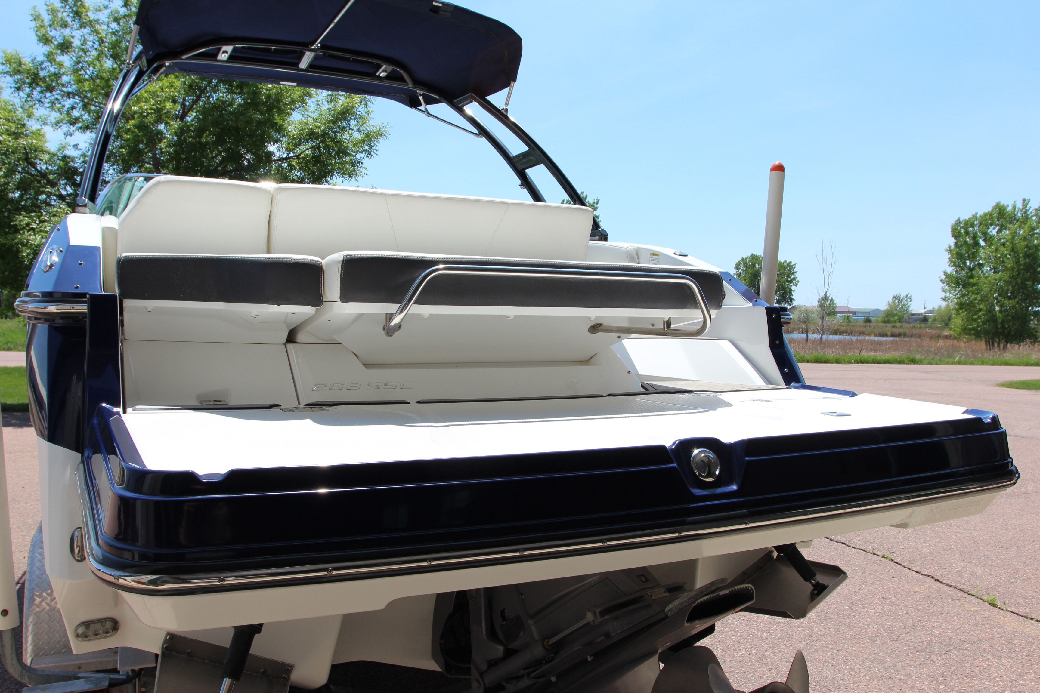 2015 Monterey 268SSC boat parked on shore.