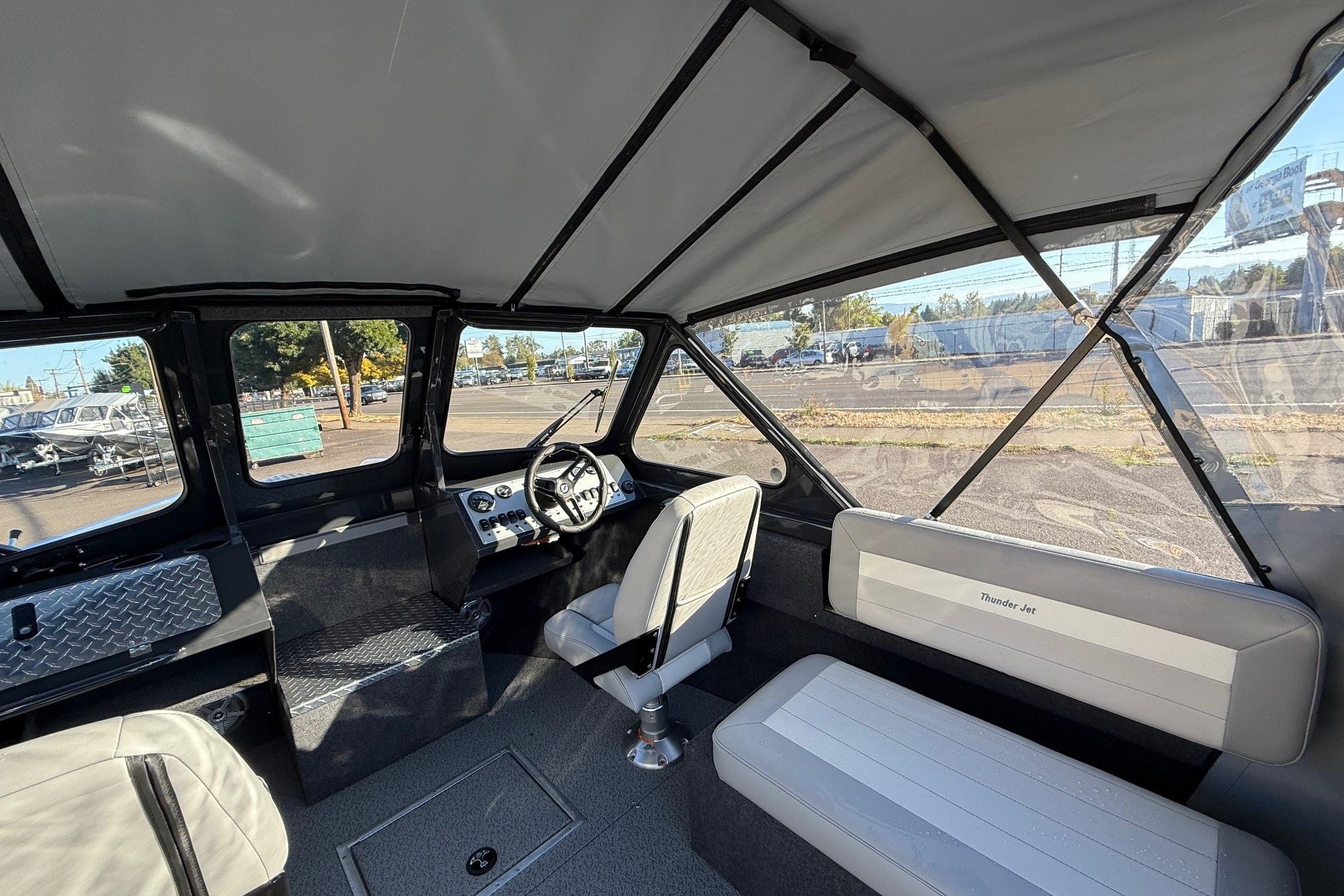 2026 Thunder Jet 200 Luxor boat interior with steering wheel and seating.