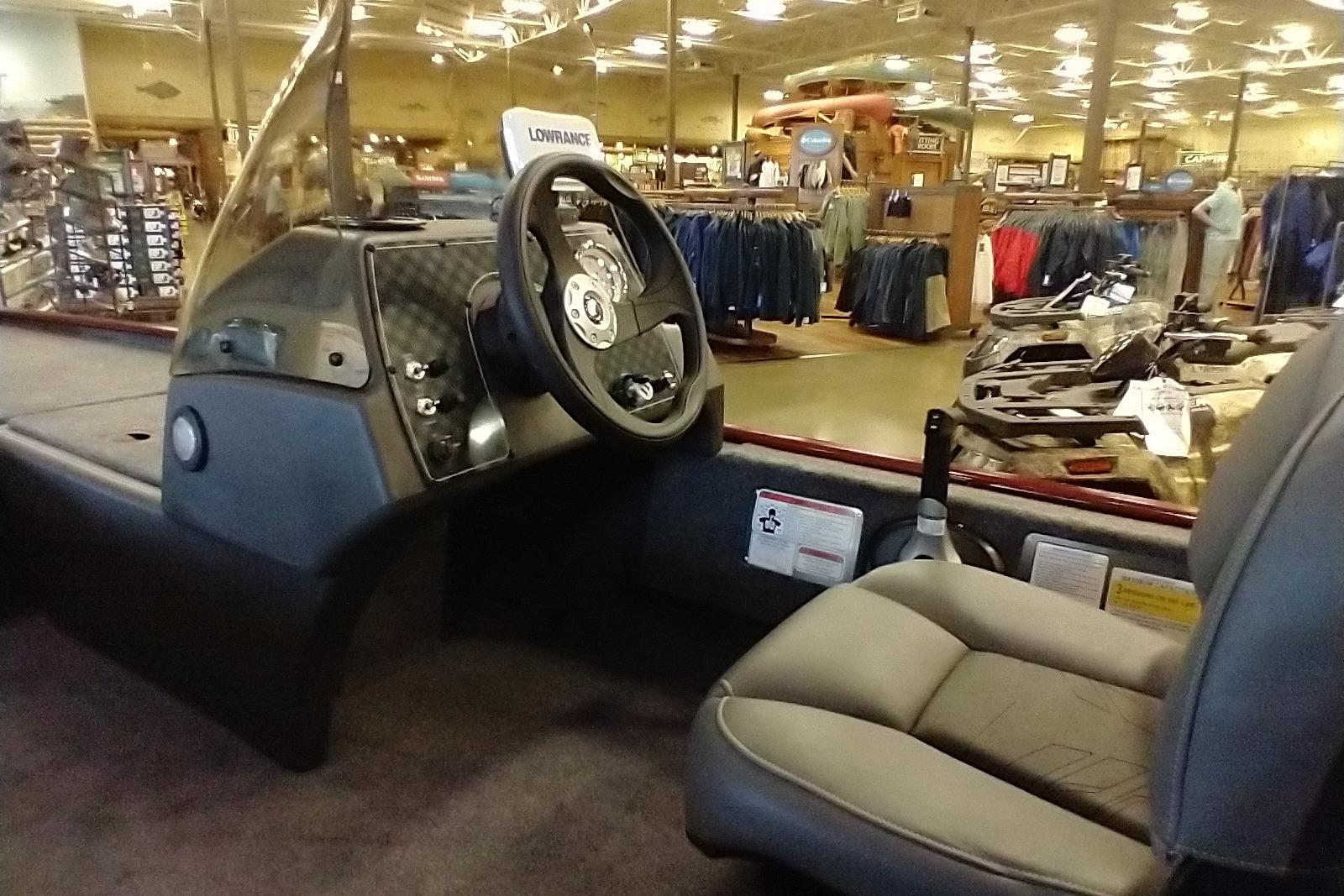 Interior of 2026 Tracker Bass Tracker Classic XL boat in showroom setting.
