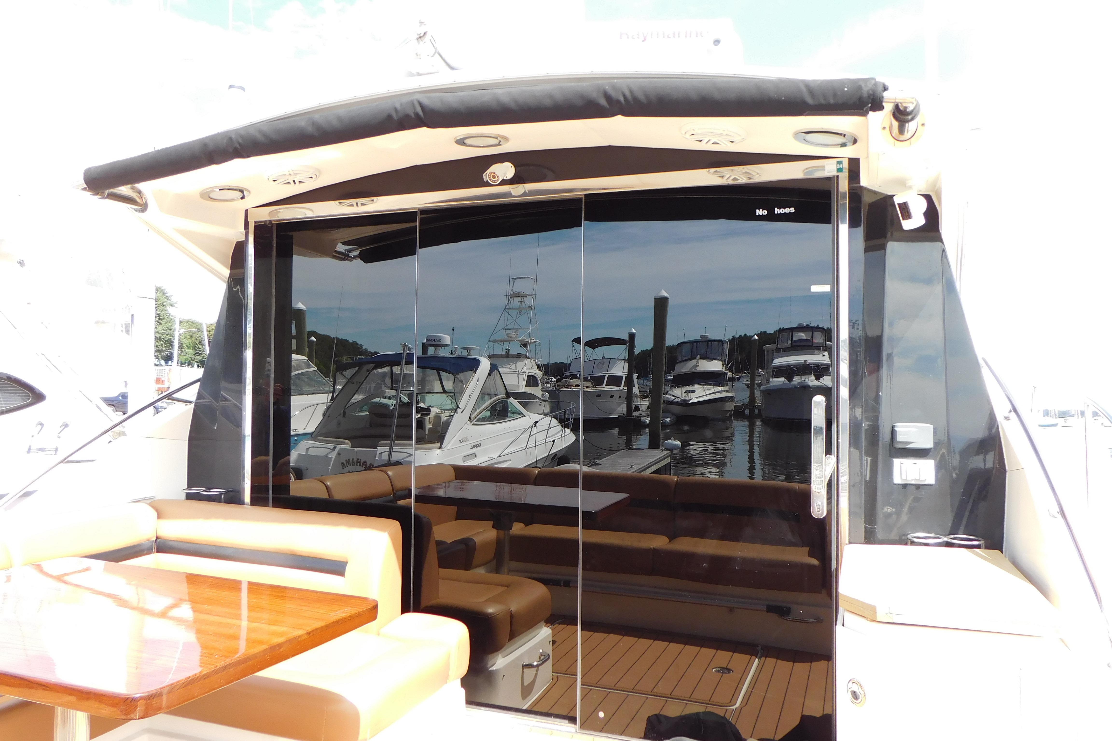 2013 Sea Ray 510 Sundancer yacht with sleek glass doors and luxurious seating area.