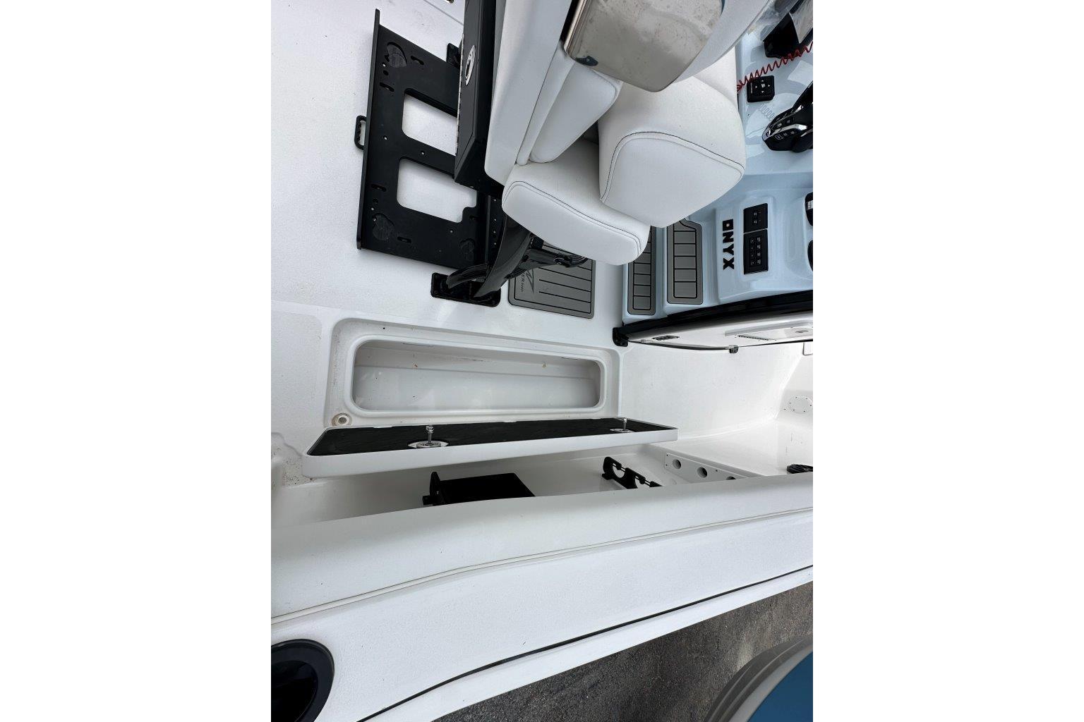 2026 Tidewater 272 LXF boat interior with white seating and storage compartments.