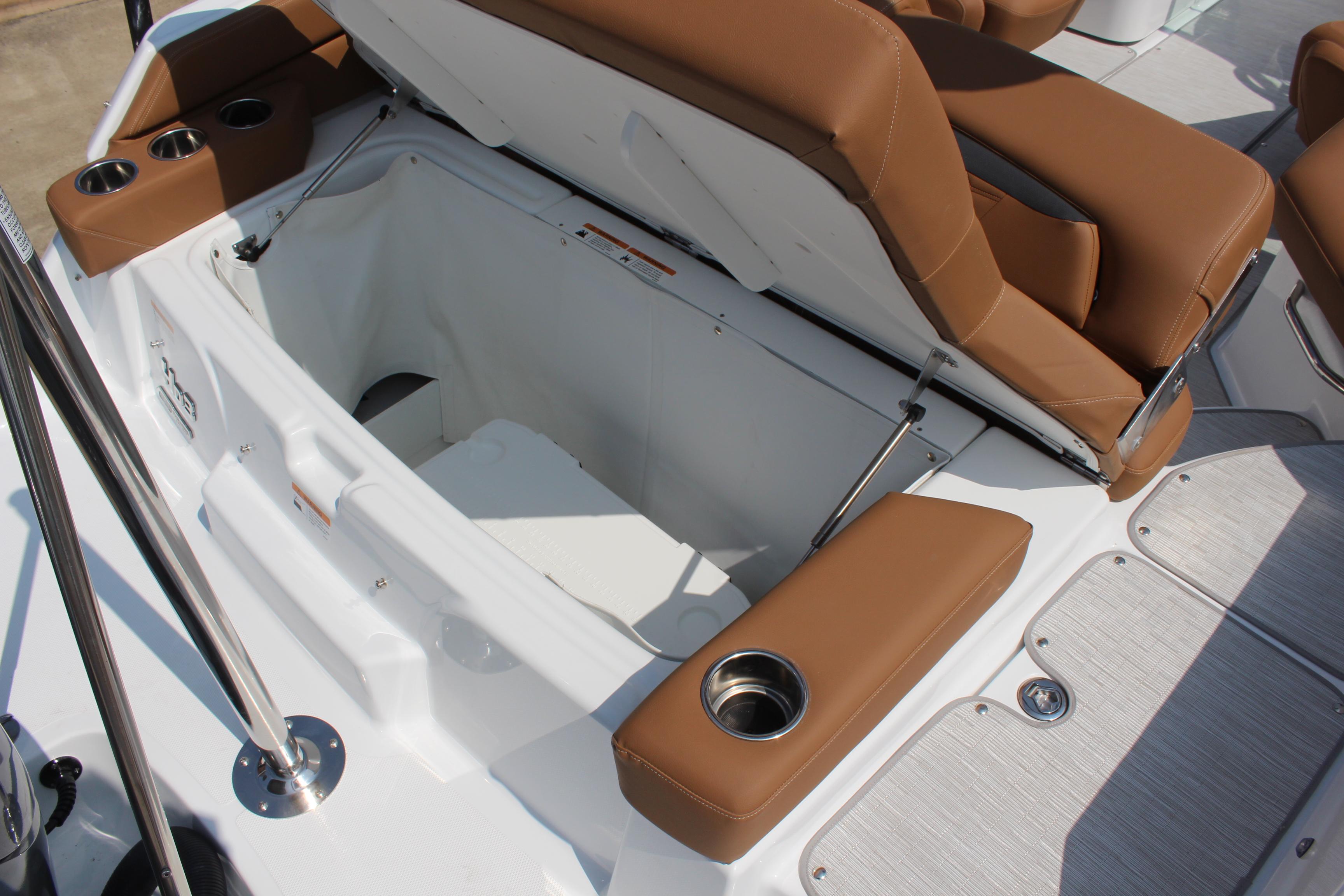 2025 Four Winns HD3 OB boat with open storage compartment and brown seating.