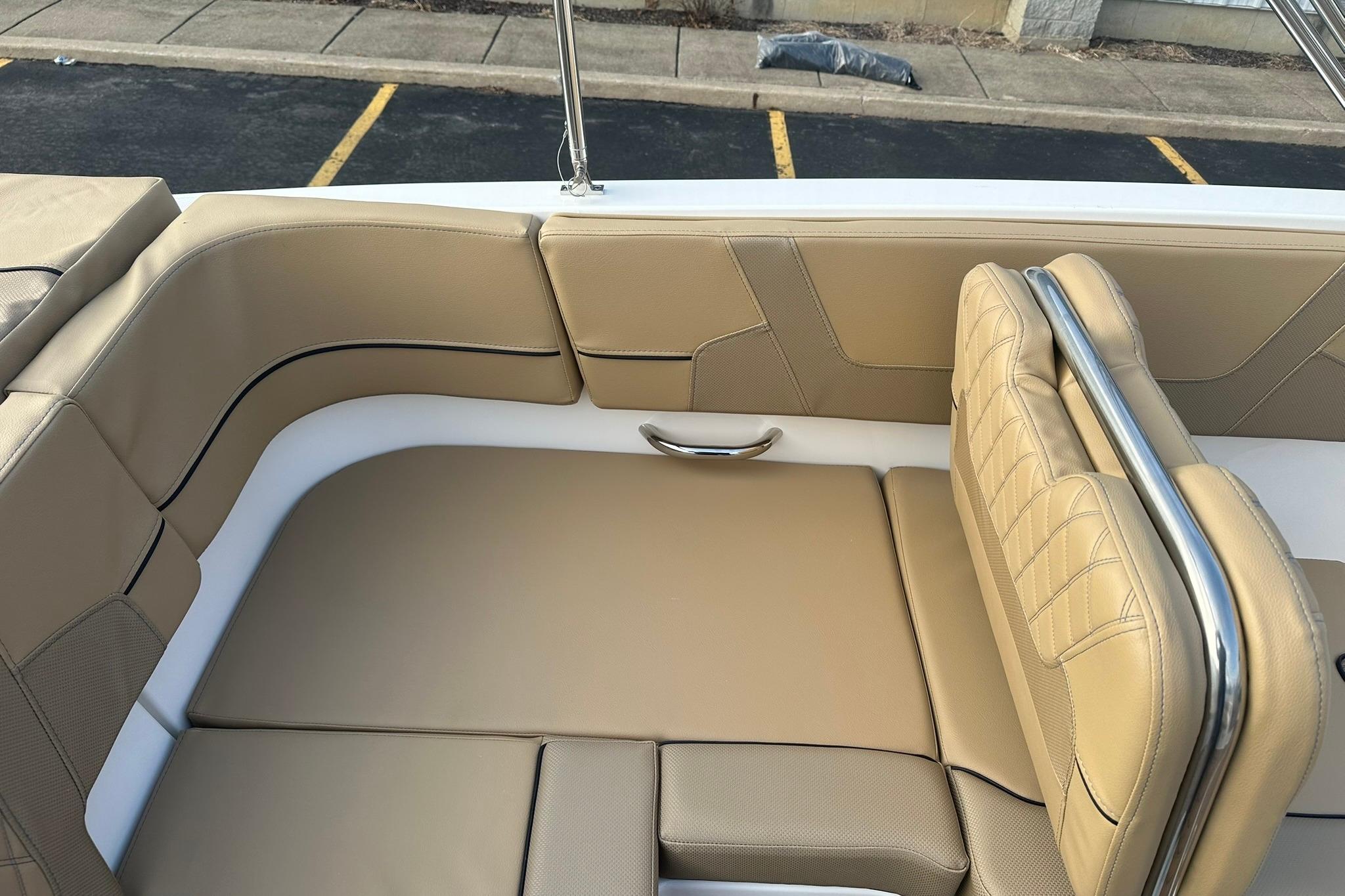 2026 Bayliner VR6 Bowrider OB interior with tan leather seating and stainless steel accents.