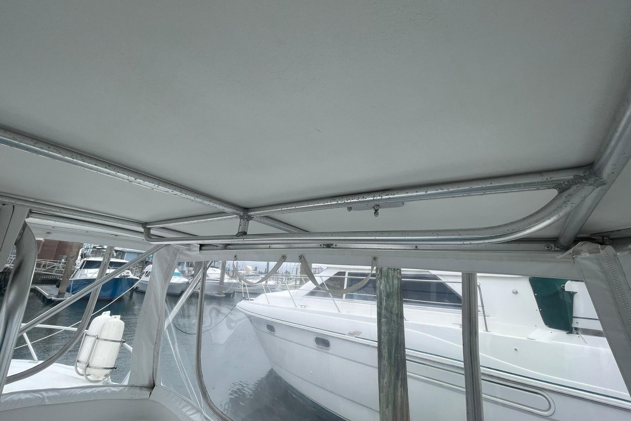 1996 Luhrs Tournament 290 Open boat interior with metal frame and marina view.
