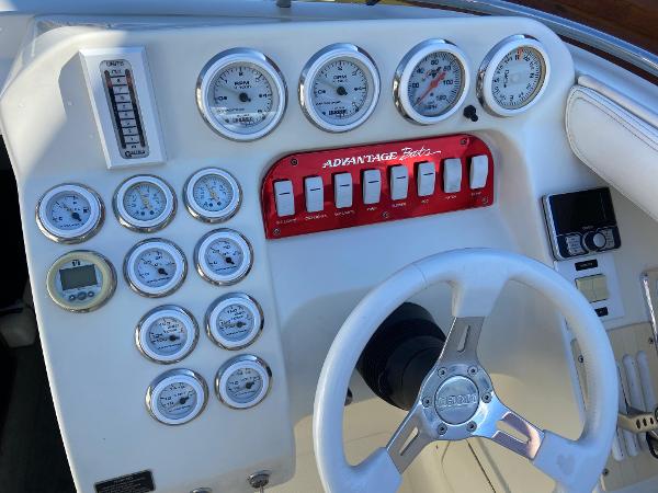 2002 Advantage Victory boat dashboard with gauges and steering wheel.