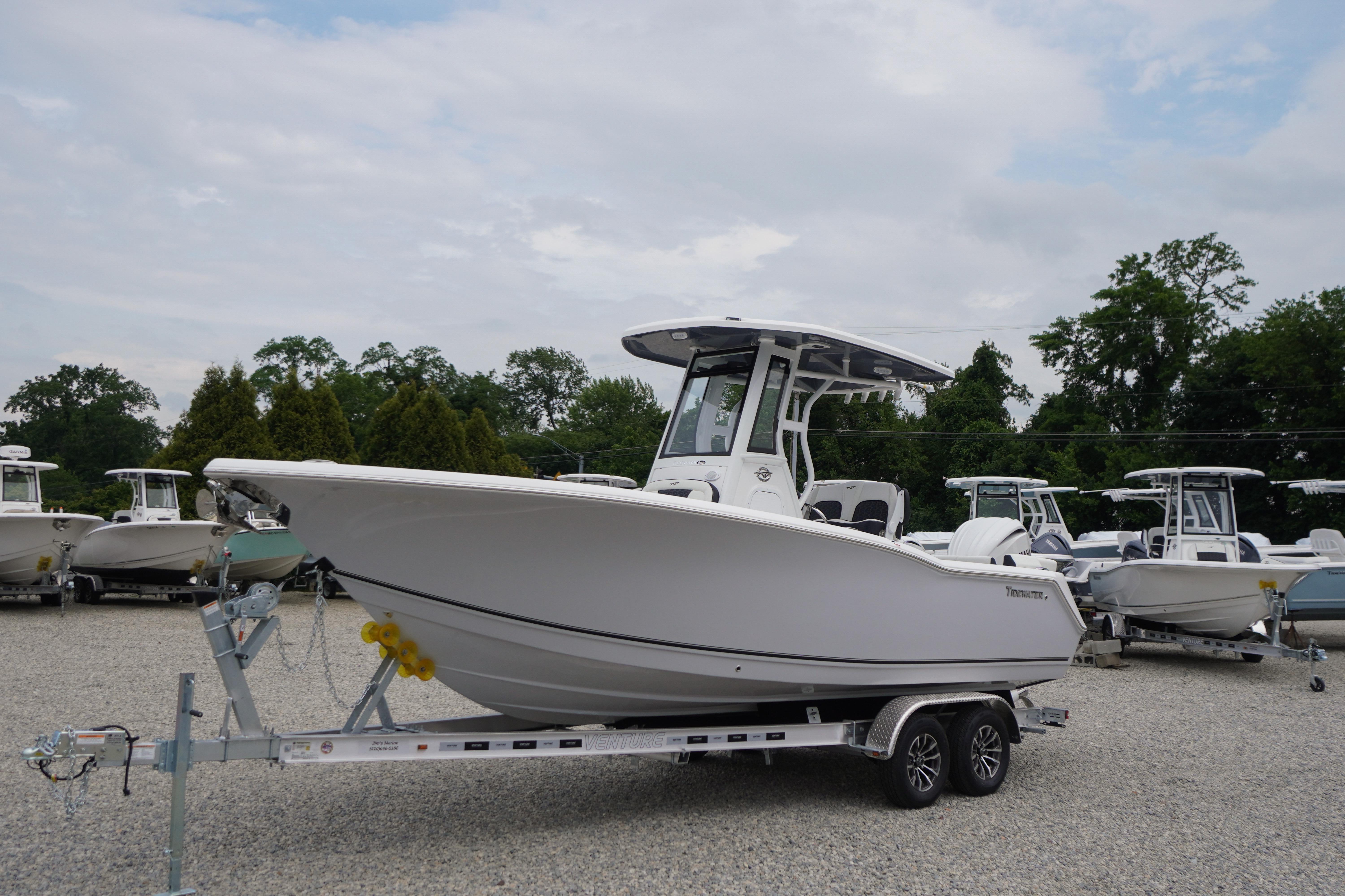 2026 Tidewater 232 SS boat on trailer, parked outdoors with other boats.