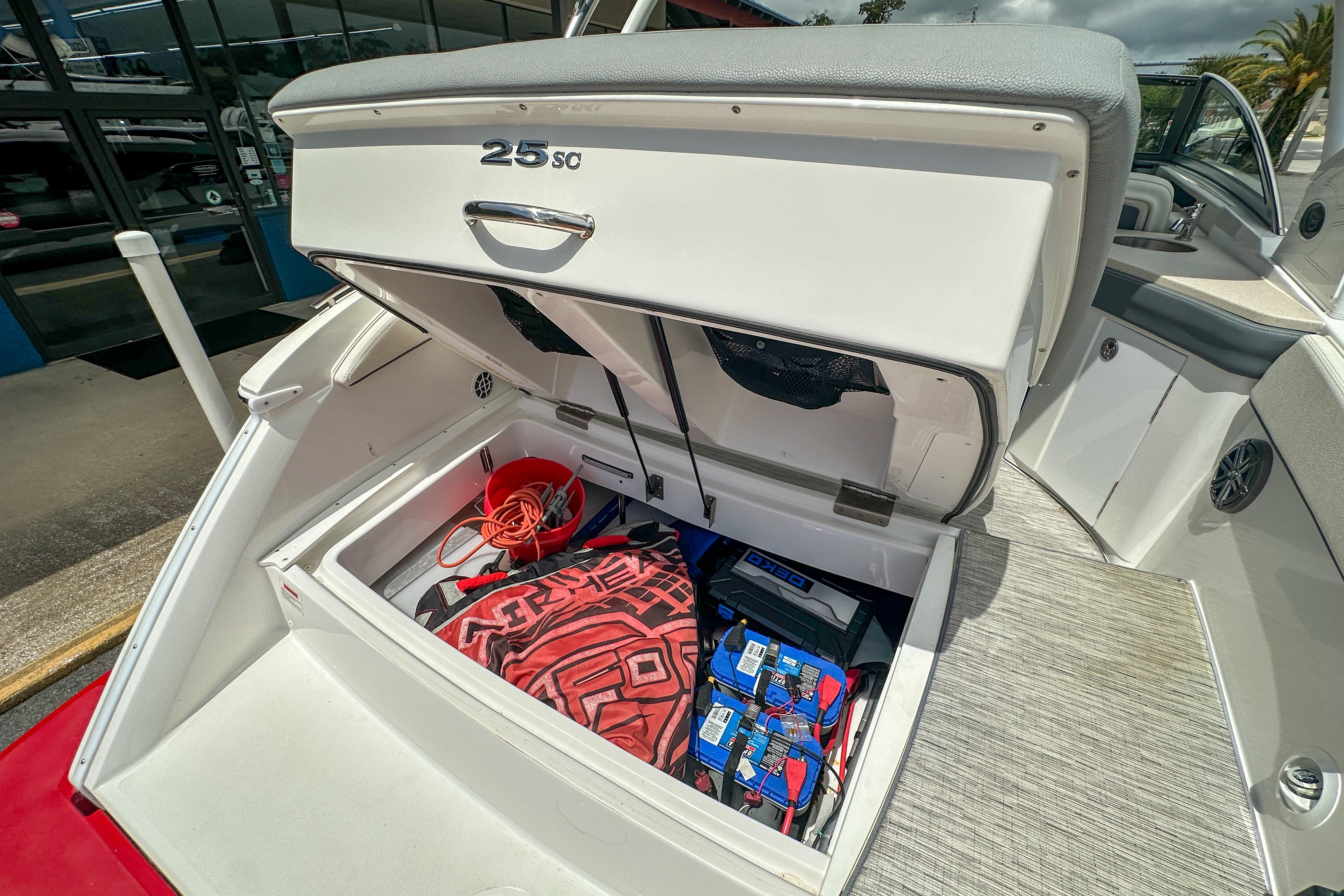 2022 Cobalt 25SC boat storage compartment with equipment and accessories.